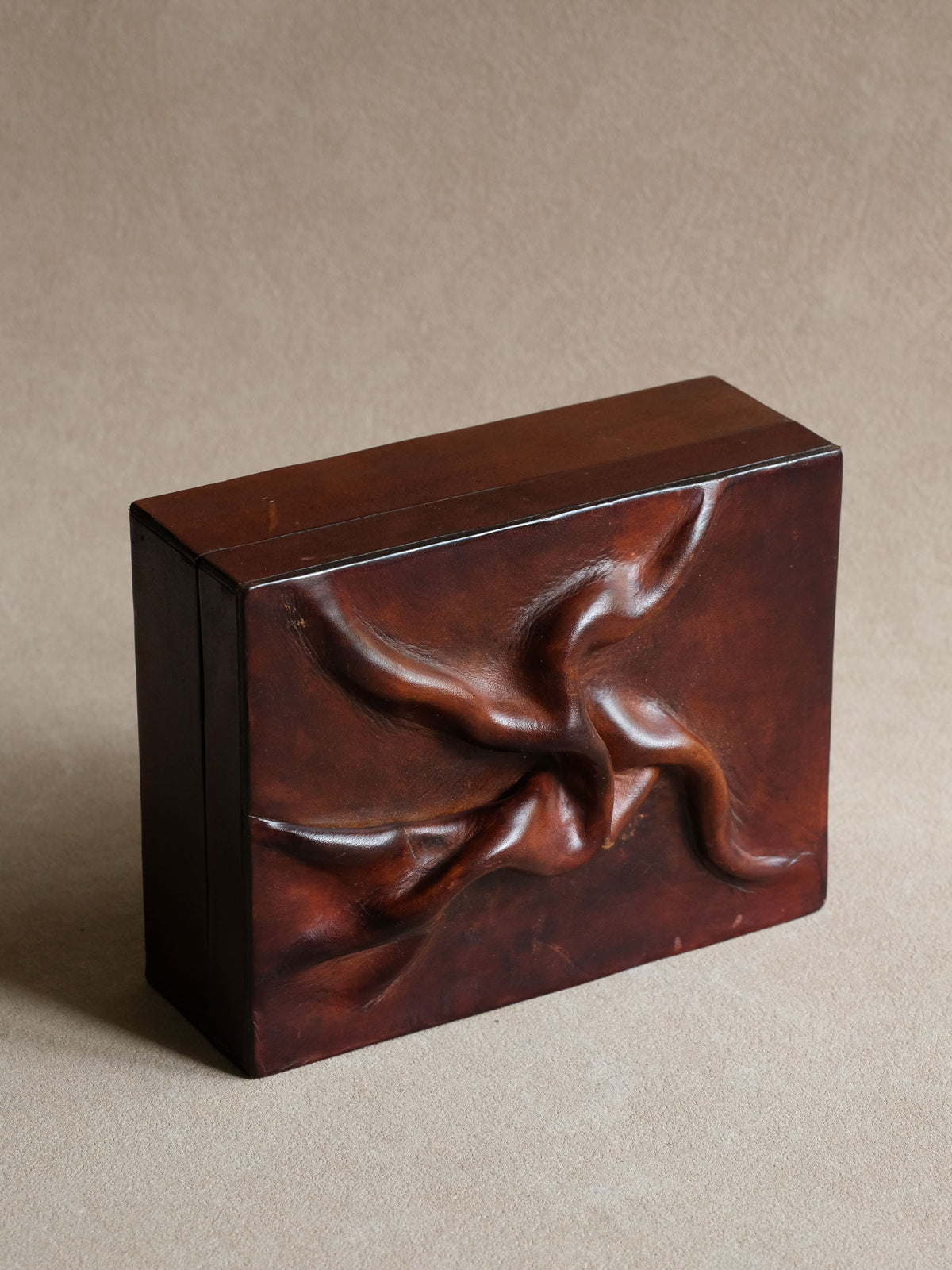 Vintage Polish jewellery box in deep burgundy-red genuine leather with strongly modelled sculptural relief across the lid.