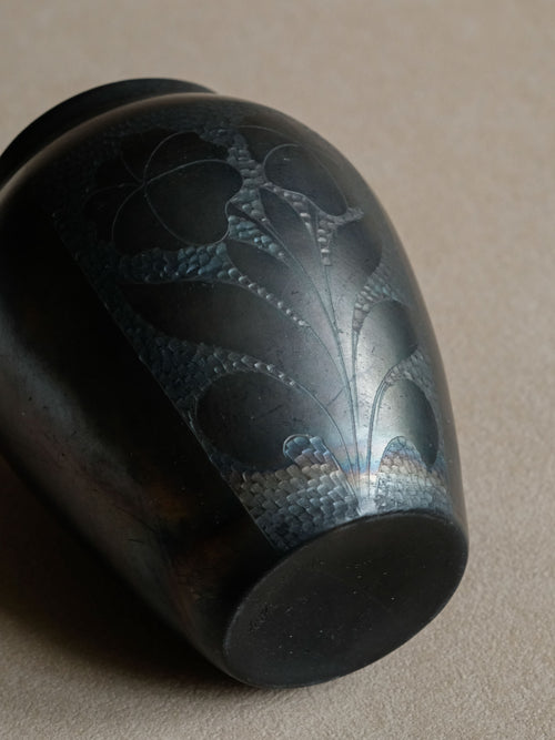 Alternate view of the Art Deco black ceramic vase showing the incised floral decoration and rounded lower body.