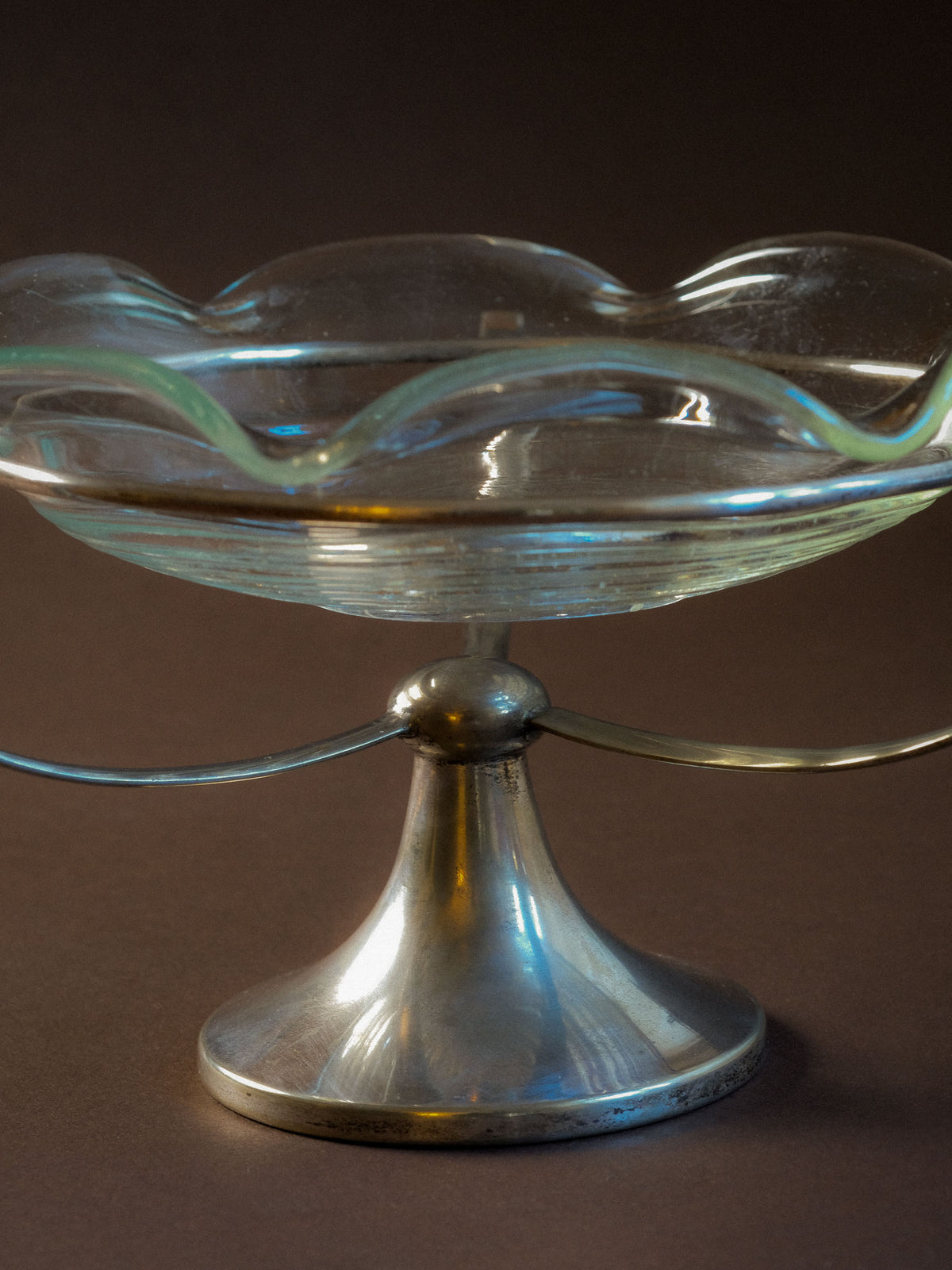Close view of the vintage clear glass bowl showing its shallow profile and age-appropriate surface character.