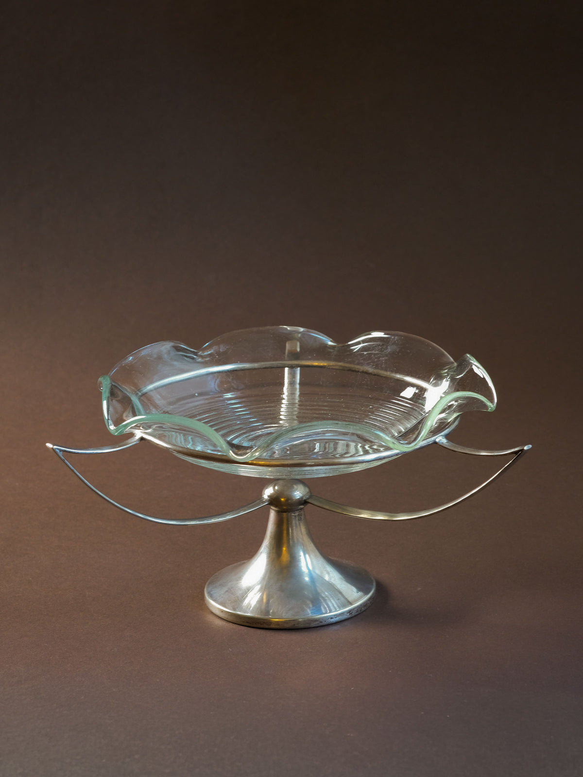 Detail of the slender EPNS silver-plated support with age-appropriate patina and plating wear.