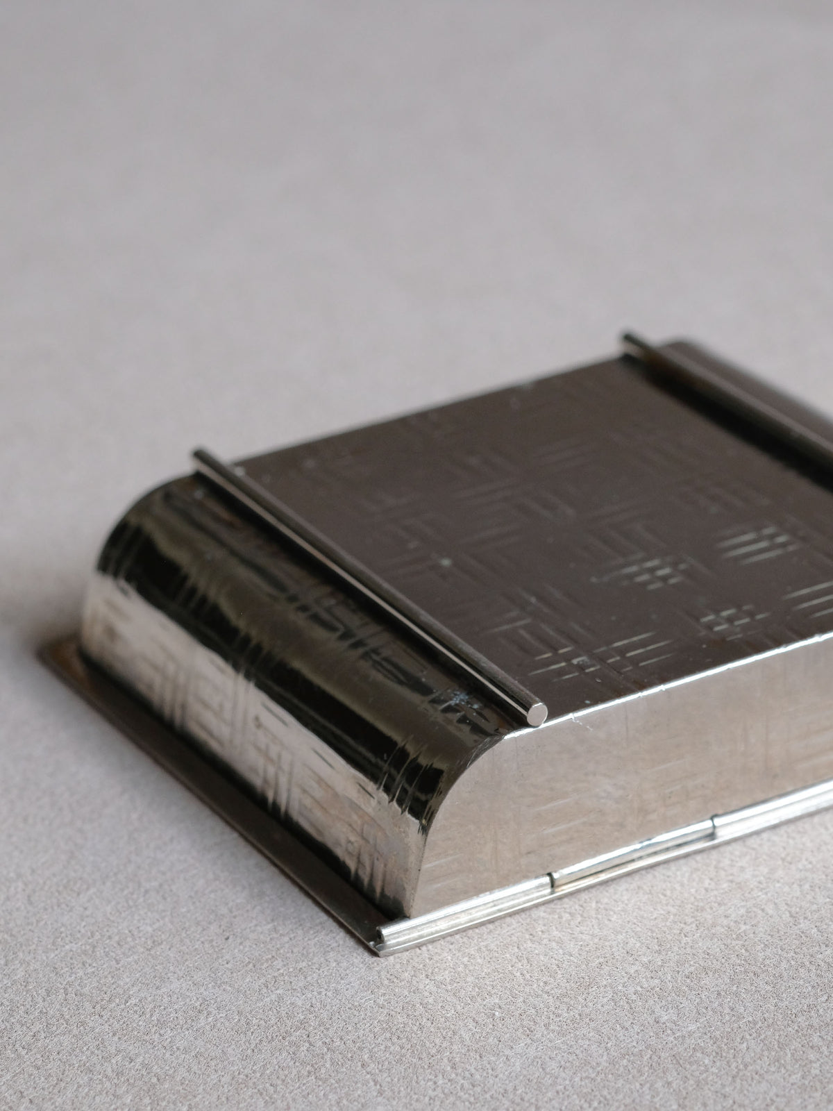 Alternate view of the Art Deco geometric table matchbox showing the low architectural form and fitted lid.