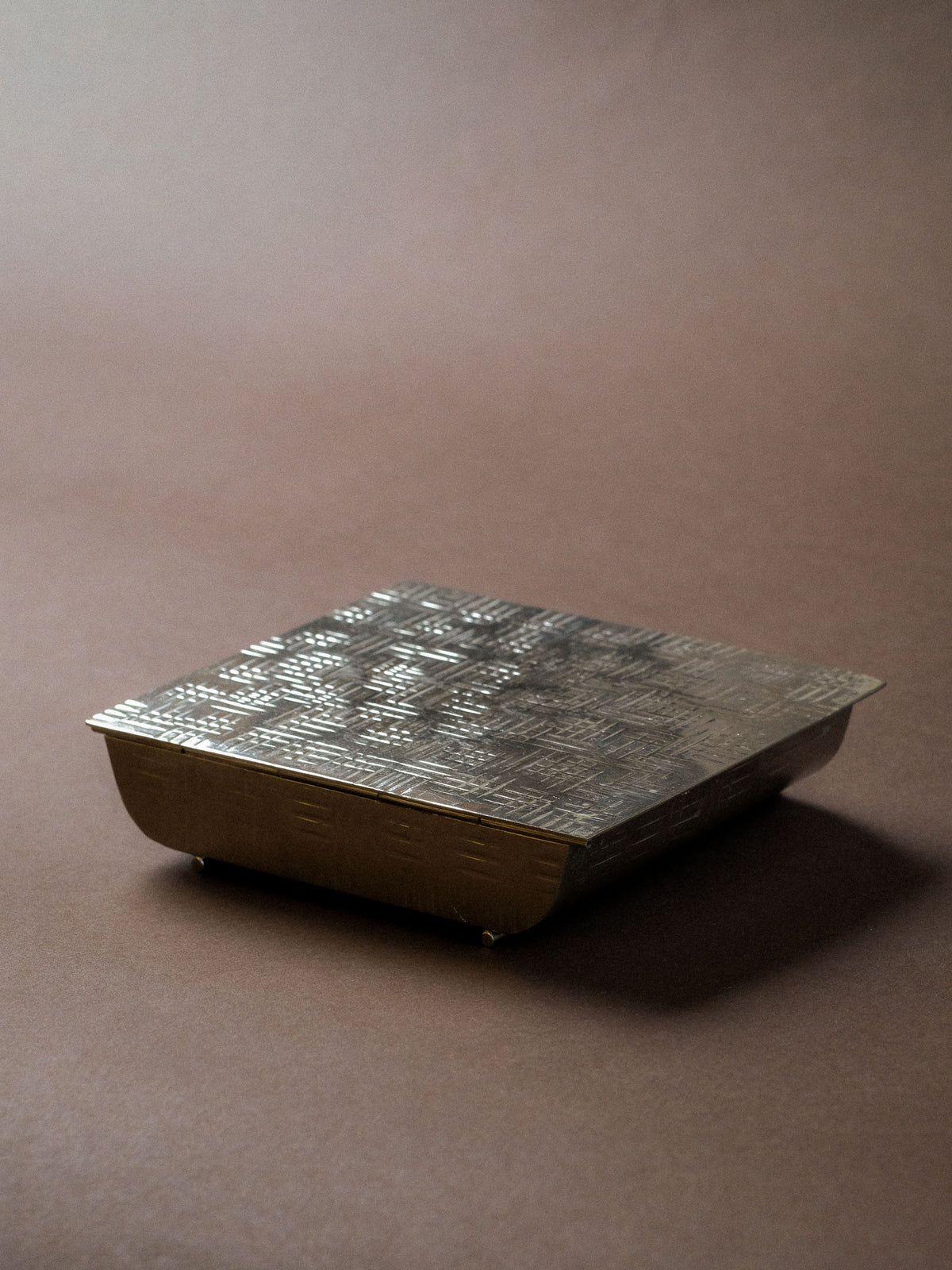 Detail view of the silver-plated Art Deco matchbox showing its compact proportions and geometric decoration.