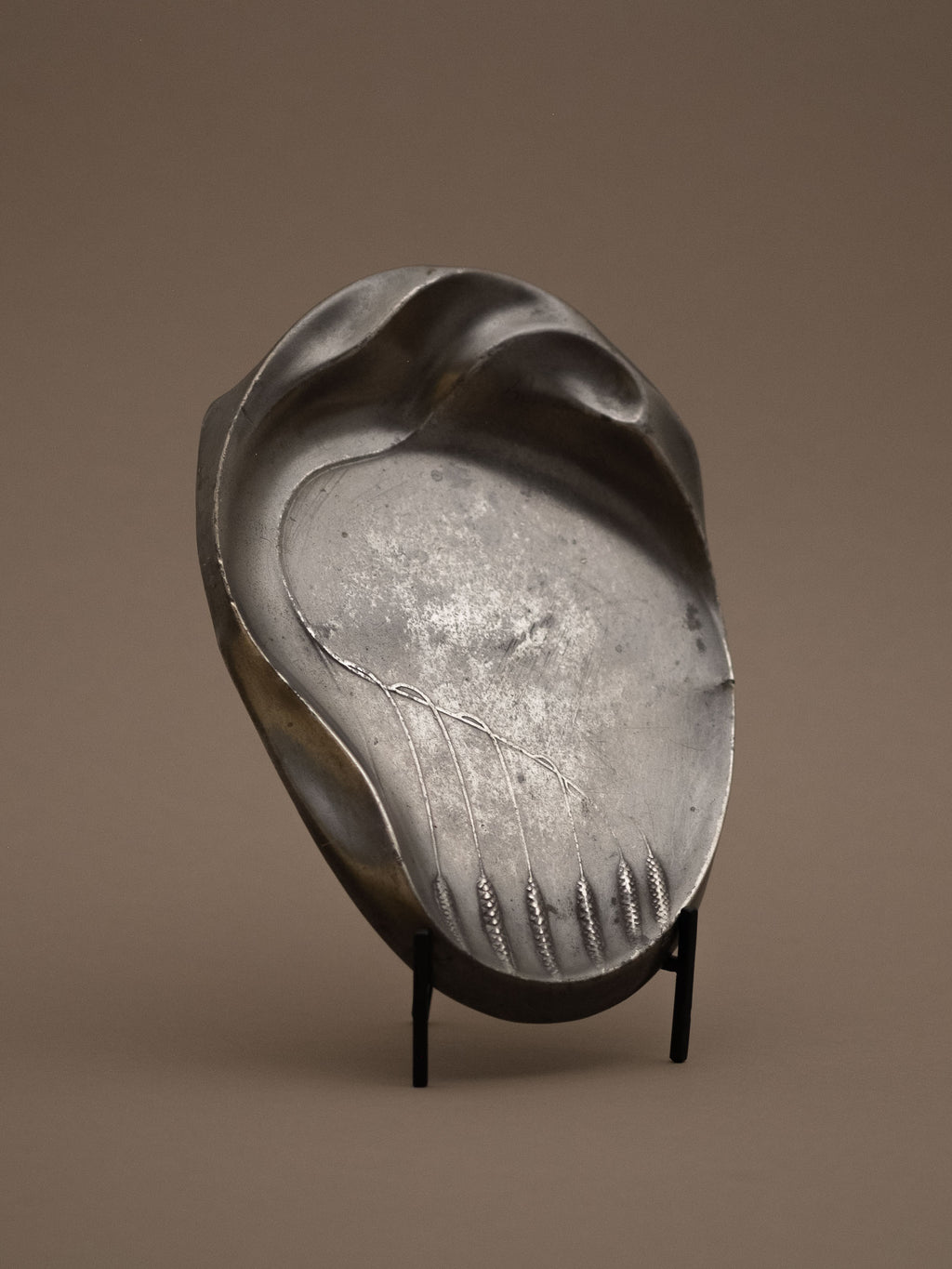 Kayserzinn Model 4411 art pewter plate displayed upright on stand against neutral background.