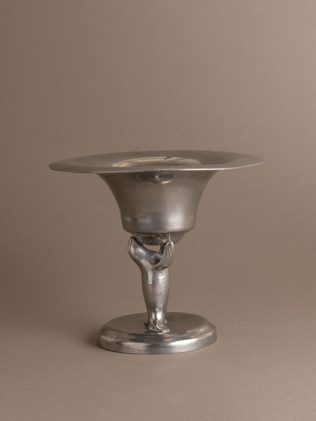 Front view of Dahlströms Tenn pewter pedestal bowl with stylised sea lion stem, Sweden, c. 1930s.