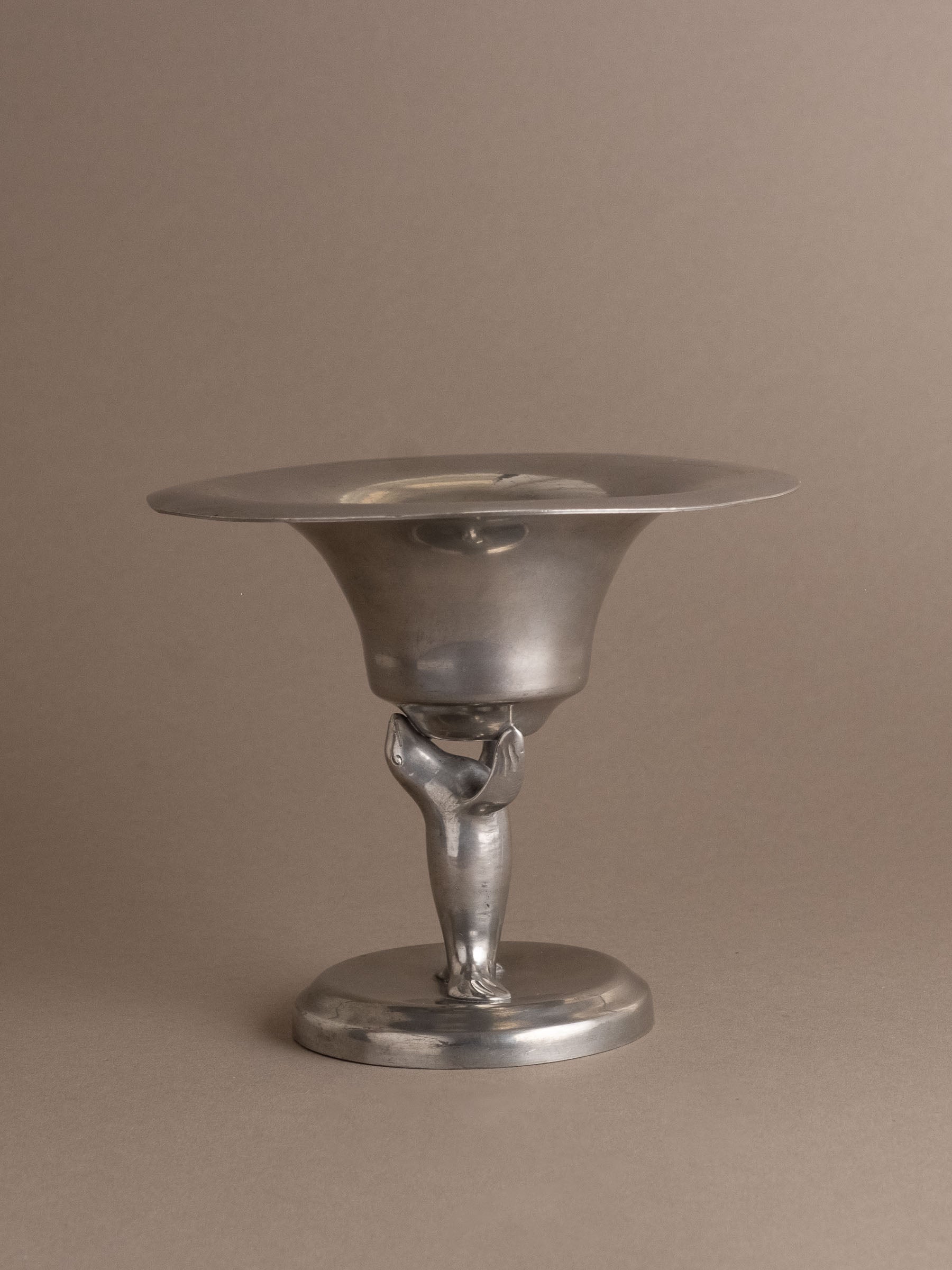 Front view of Dahlströms Tenn pewter pedestal bowl with stylised sea lion stem, Sweden, c. 1930s.