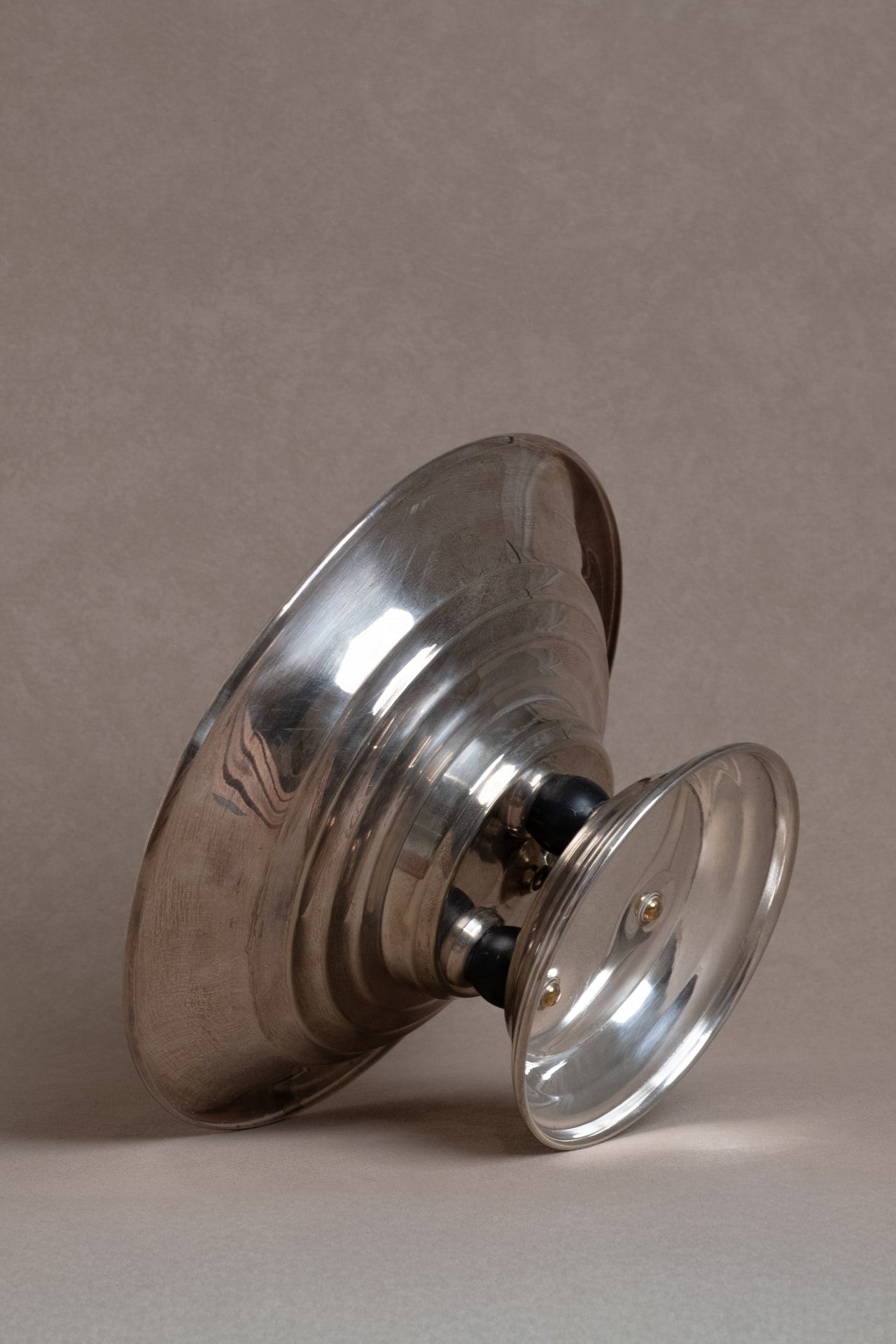 Profile view of the Art Deco EPNS silver pedestal tazza bowl positioned on its side.