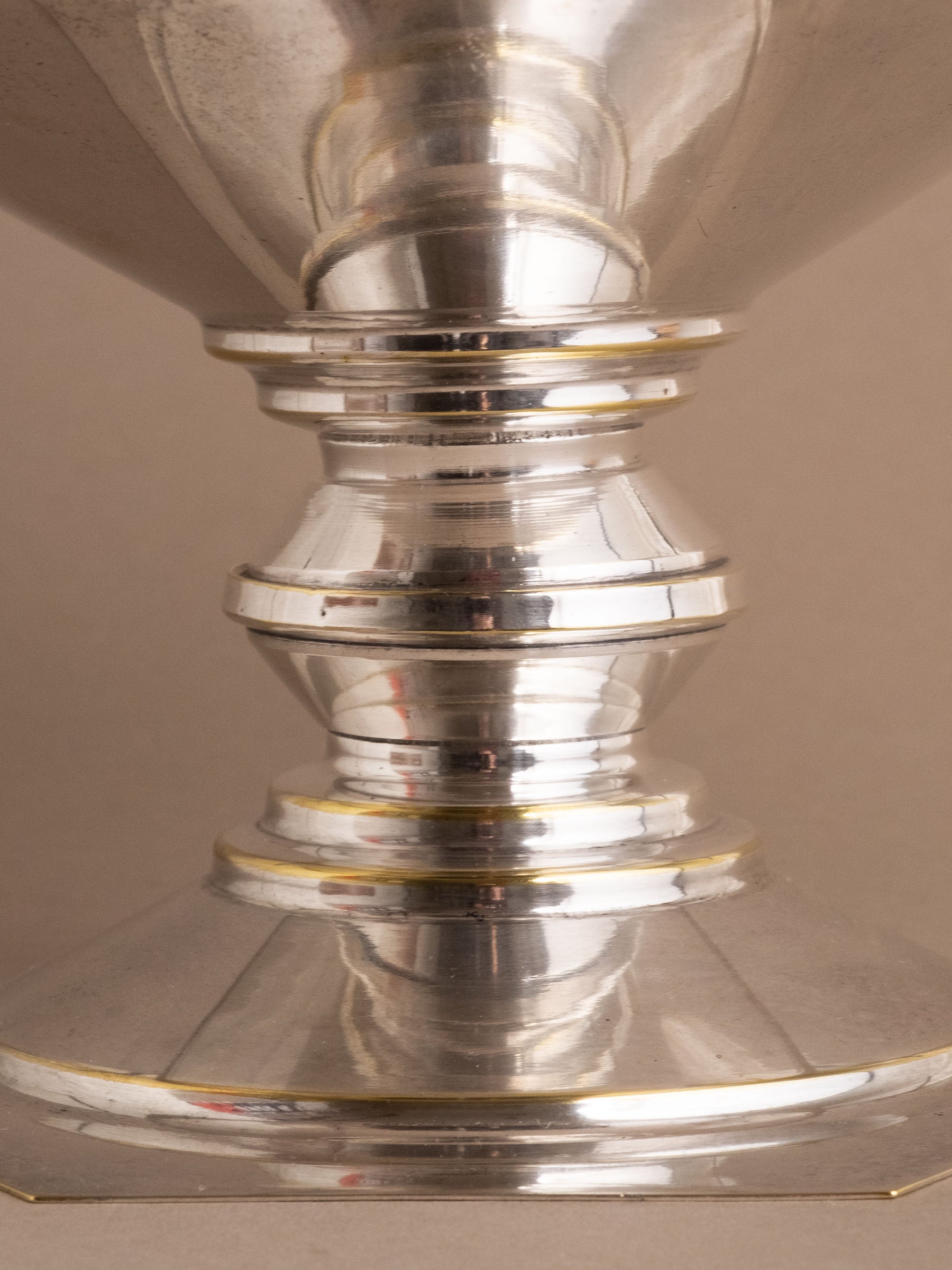 Close-up of the pedestal stem and lower section of the silver-plated bowl showing light surface wear.
