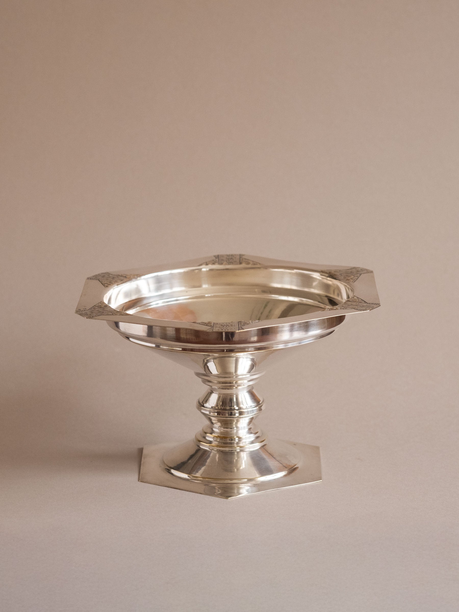 Front view of the Art Deco silver-plated pedestal bowl showing the shallow bowl, turned stem, and hexagonal foot.