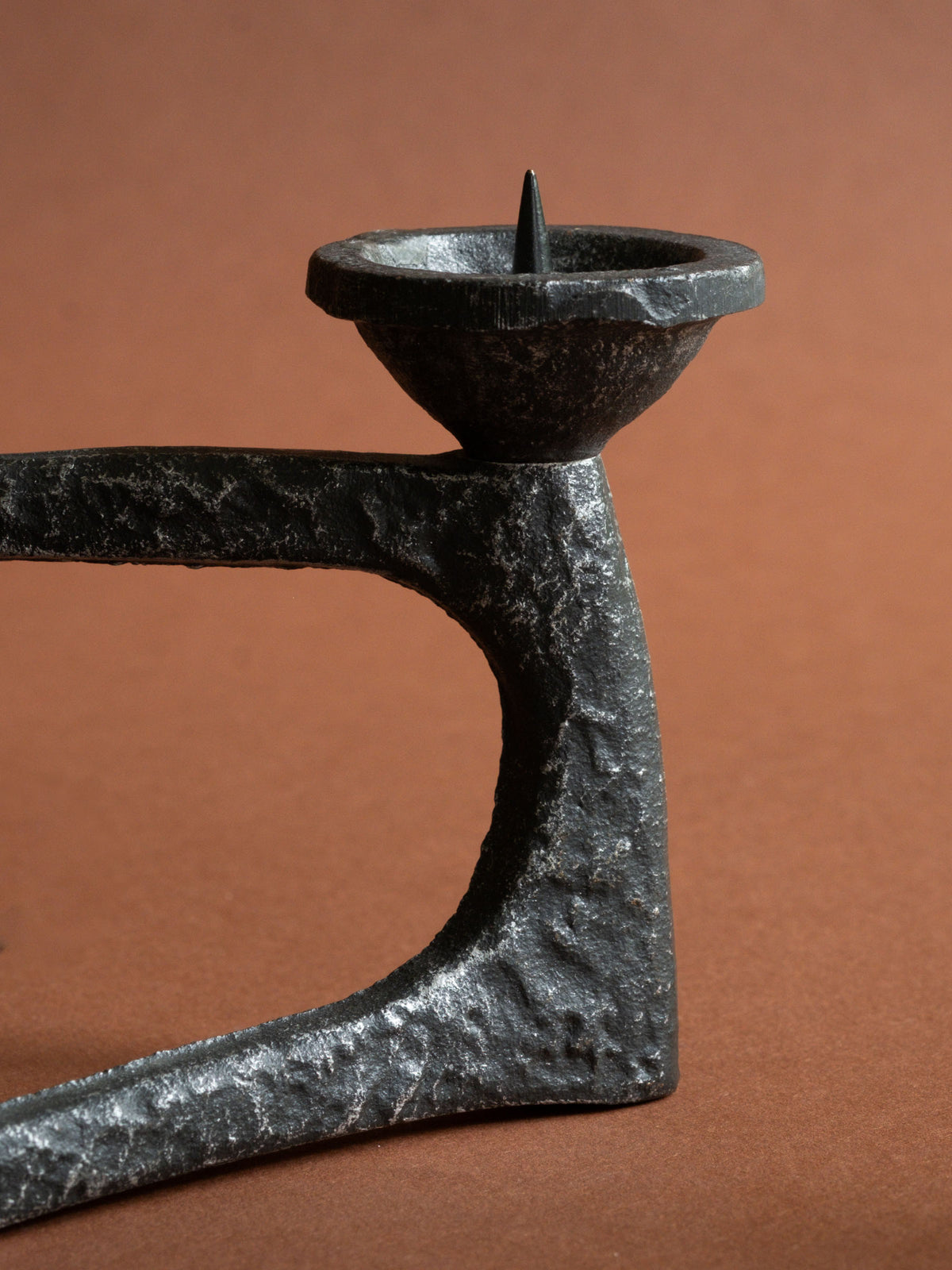 Close-up of one pricket candle bowl and the heavily textured cast iron corner.