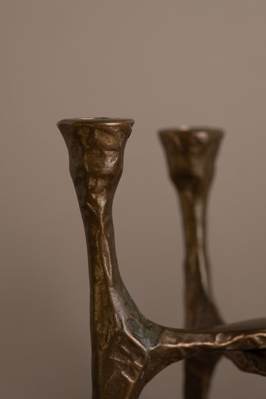 Close-up of bronze candle cup on Brutalist four-arm candleholder, Germany, 1970s.