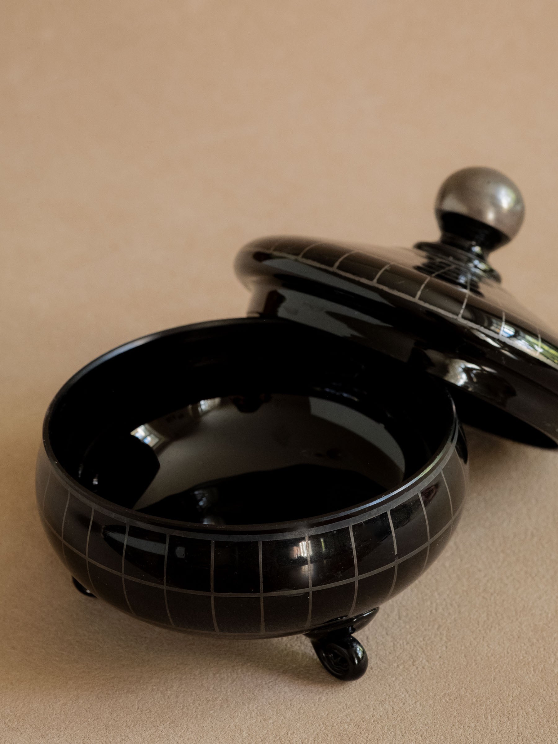 Black Hyalith glass box shown open to reveal the glossy dark interior and removable lid.
