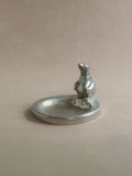 Wide view of a pewter polar bear figural dish, showing the small sculptural bear detail and shallow circular dish.
