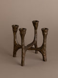 Brutalist four-arm bronze candleholder, Germany, 1970s, full view on neutral background.
