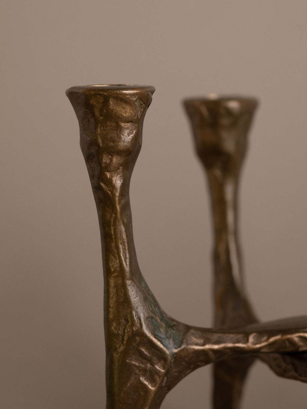 Close-up of bronze candle cup on Brutalist four-arm candleholder, Germany, 1970s.