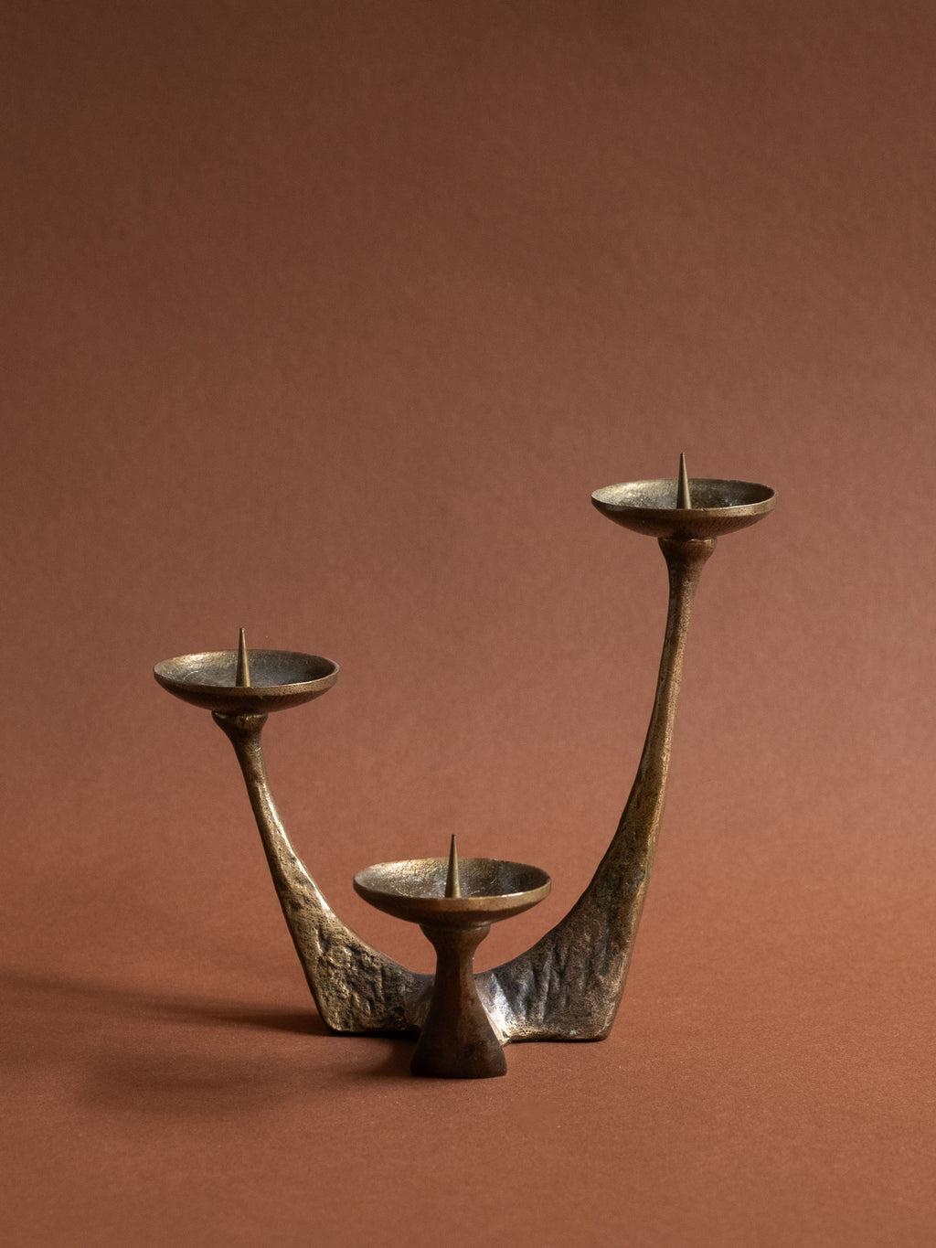 Alternate view of the German Brutalist bronze candleholder showing its low sculptural form.
