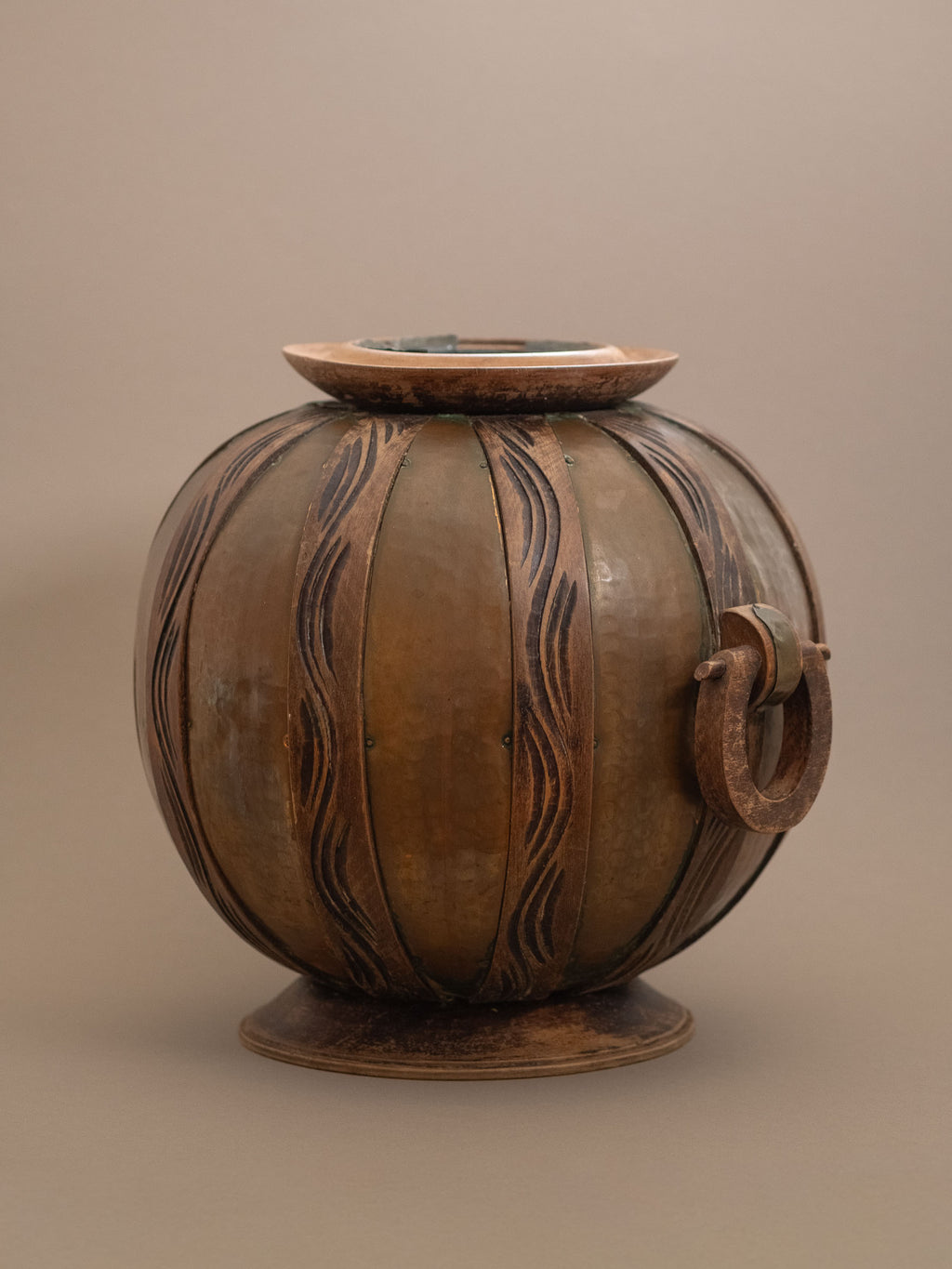Side view of attributed Gustave Serrurier-Bovy Art Nouveau copper vase with wooden overlays and circular foot, Belgium, circa 1900.