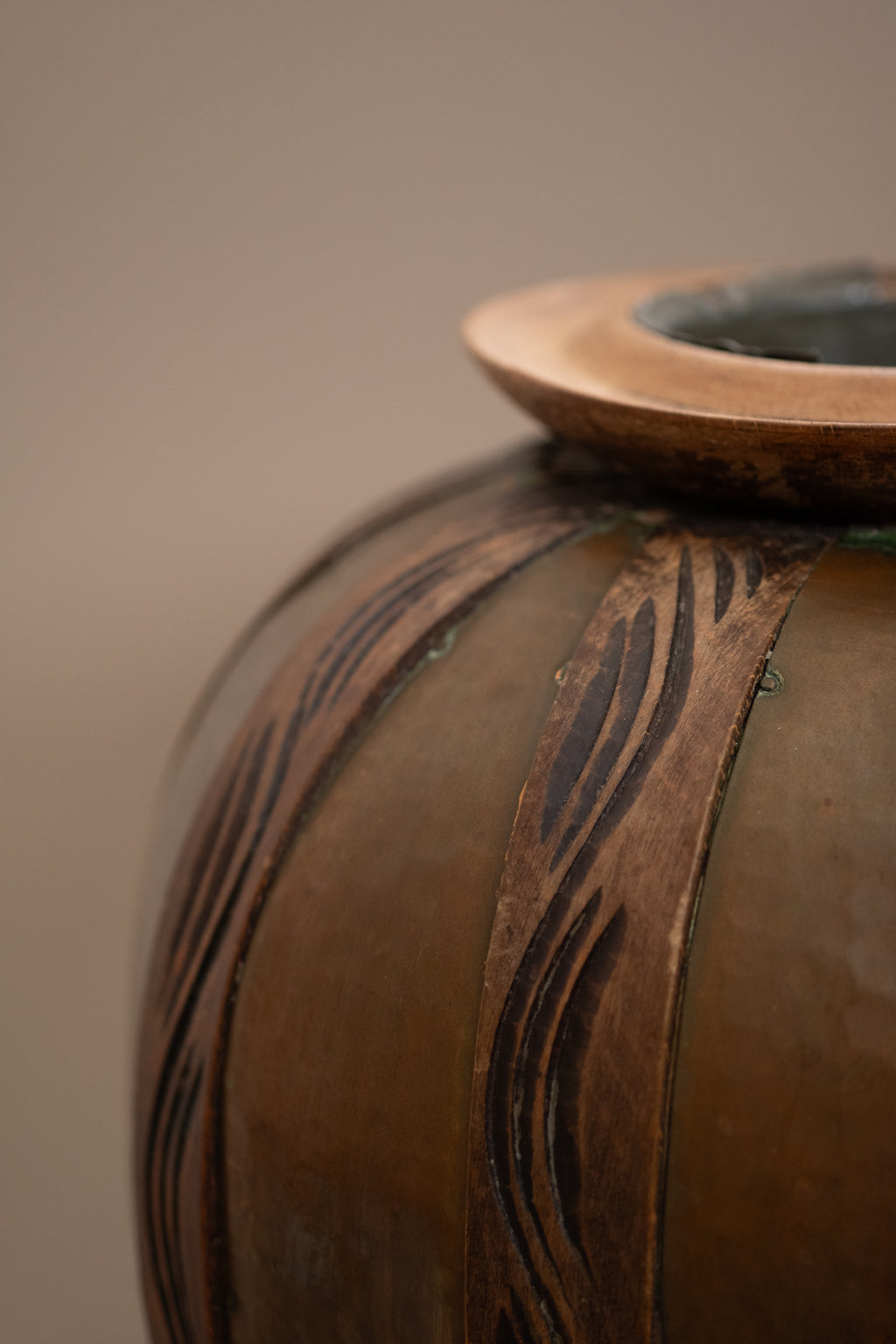 Close-up of spherical copper body with carved wood overlays on attributed Gustave Serrurier-Bovy vase, Belgium, circa 1900.