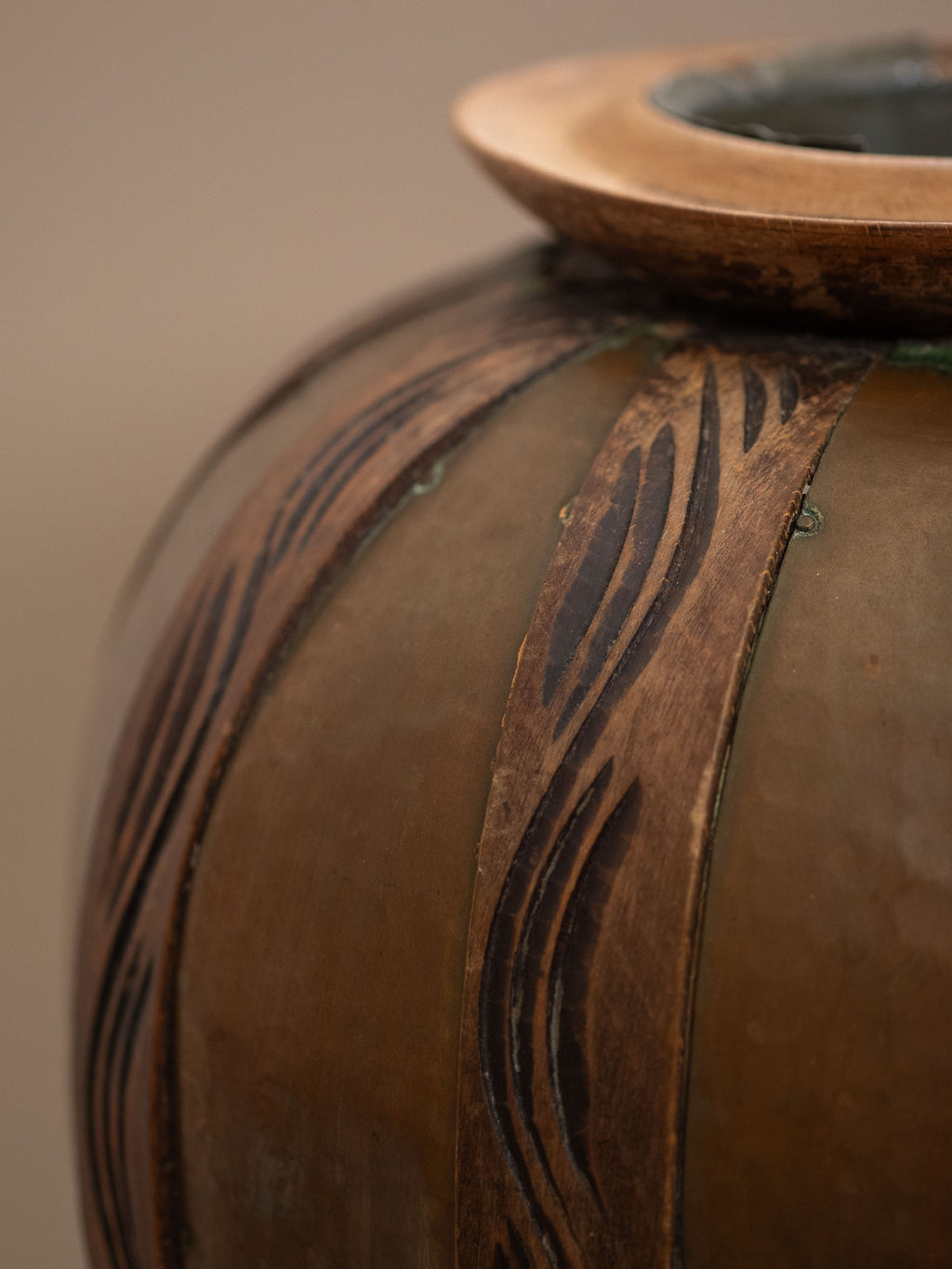 Close-up of spherical copper body with carved wood overlays on attributed Gustave Serrurier-Bovy vase, Belgium, circa 1900.