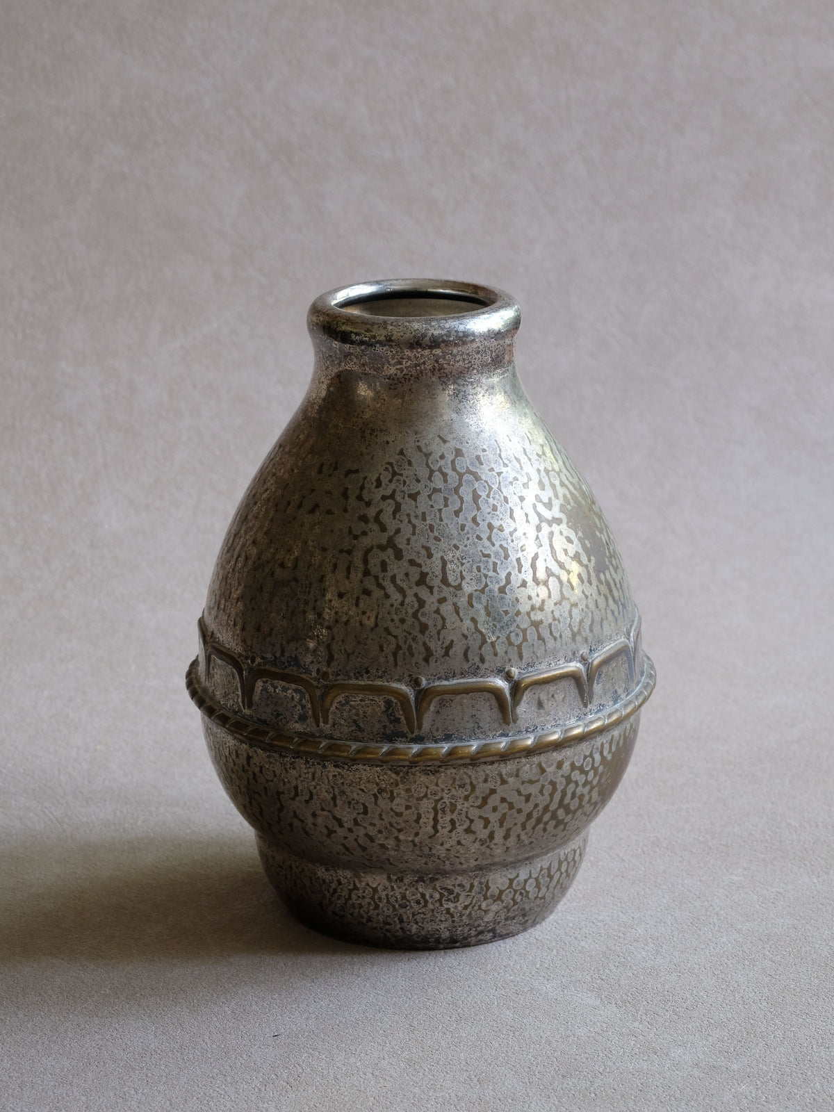 Side view of the HAGS silver-plated vase highlighting the repeating raised geometric band across the hammered body.