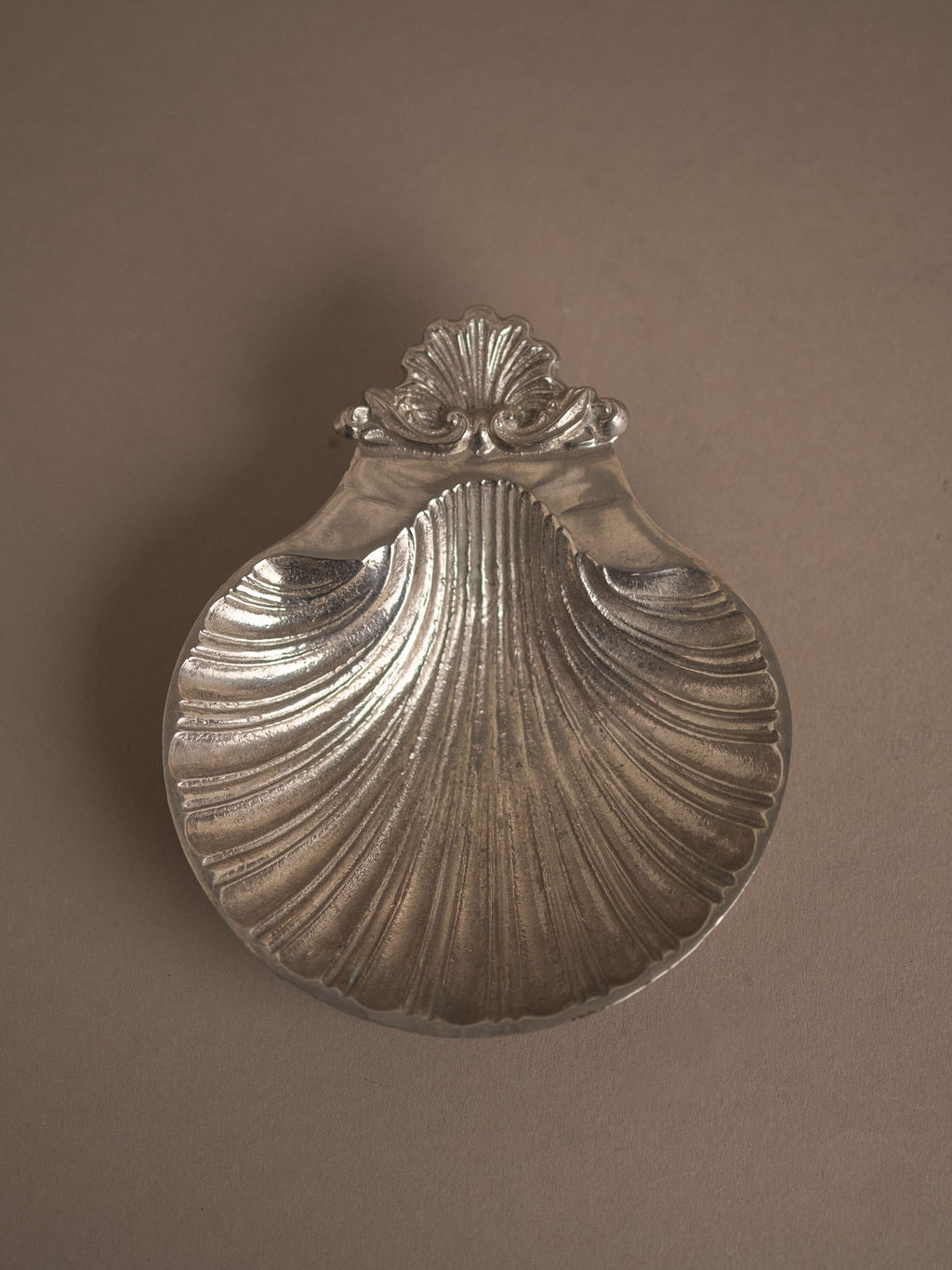 Reverse view of the Hans Baier silver-plated scallop shell dish on a neutral background, showing the back of the shell form and the small shell motif at the top.