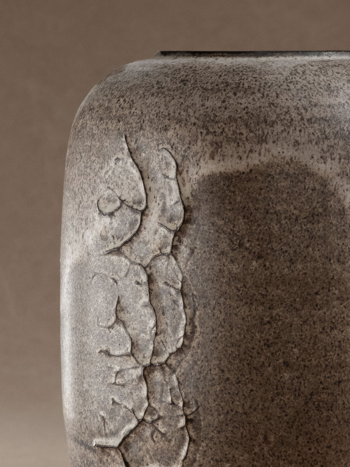 Close detail of the textured white relief and ceramic surface on the Heiner Hans Körting vase.