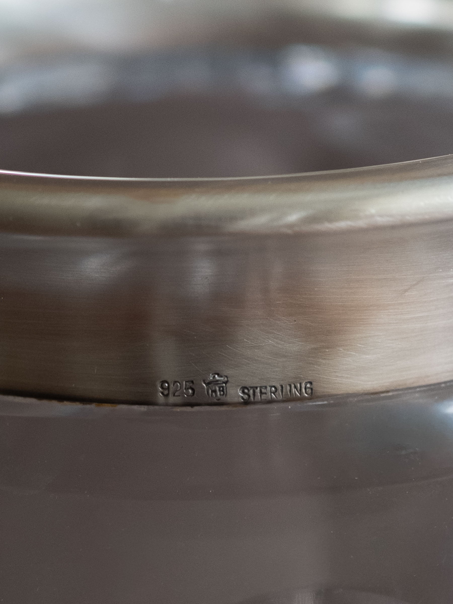 Close-up of the sterling silver rim showing the 925, HB and sterling marks on the Hermann Bauer crystal vase.

