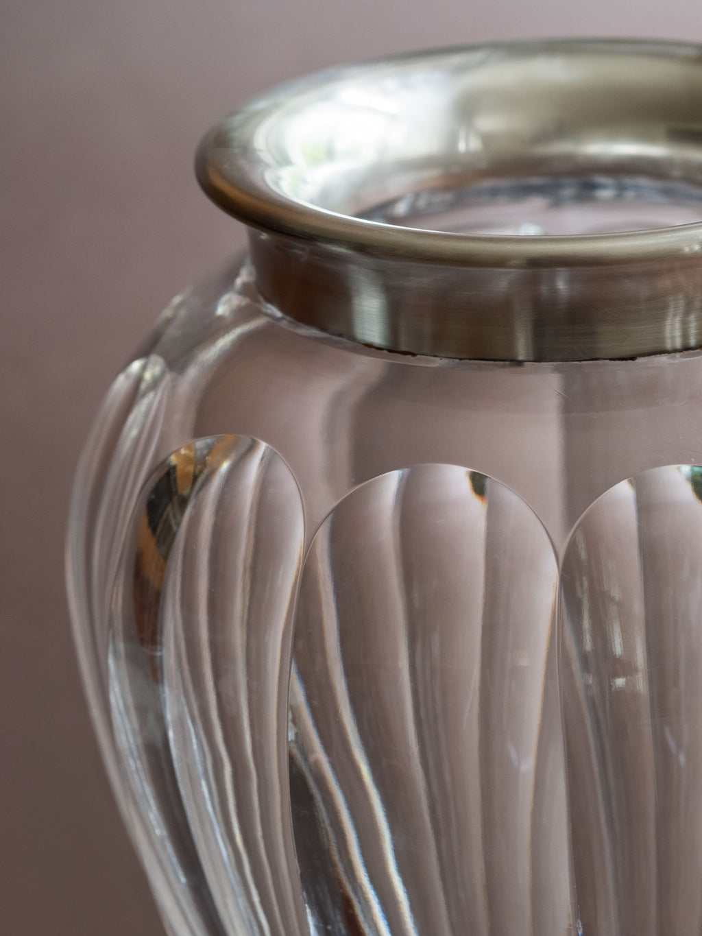 Detail view of the crystal vase showing the polished sterling silver rim and vertical cut glass surface.
