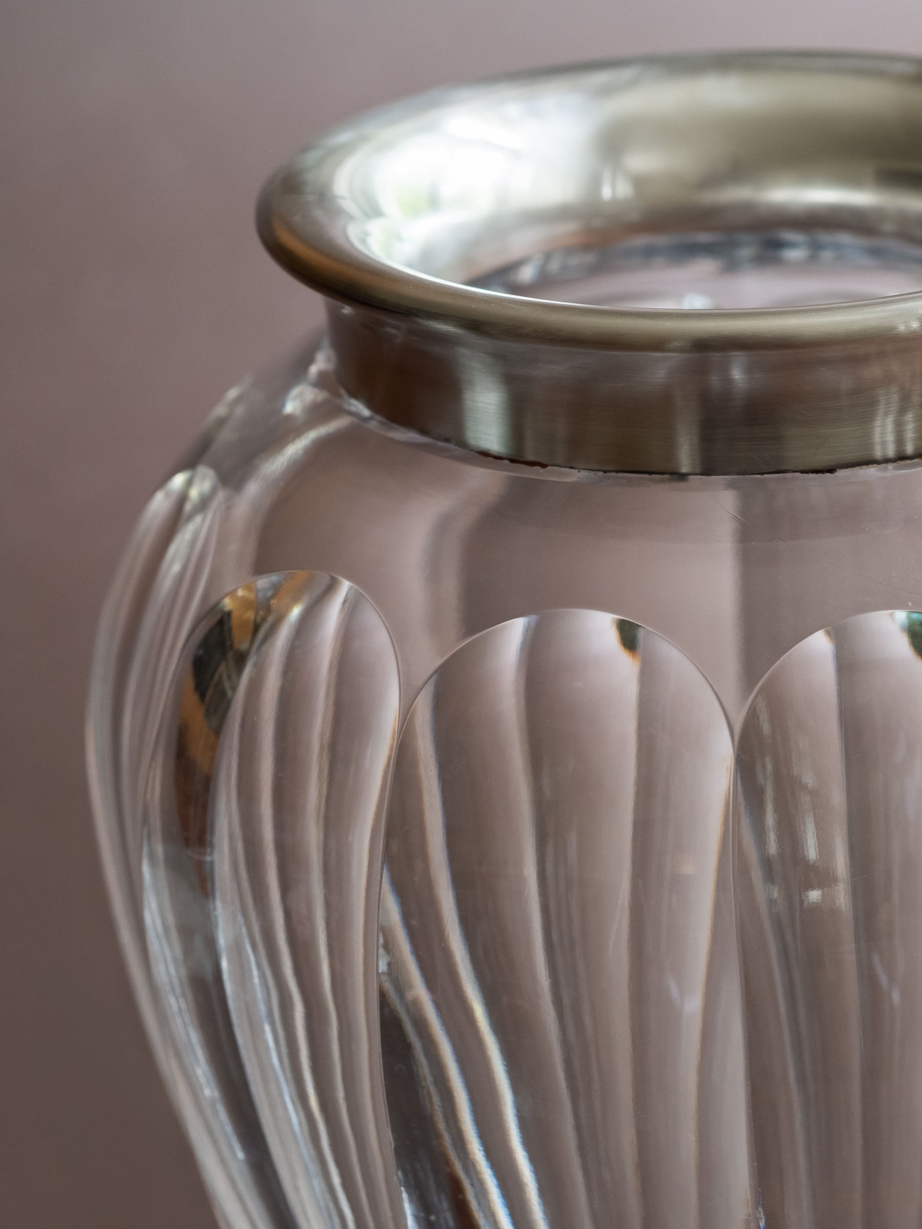 Detail view of the crystal vase showing the polished sterling silver rim and vertical cut glass surface.
