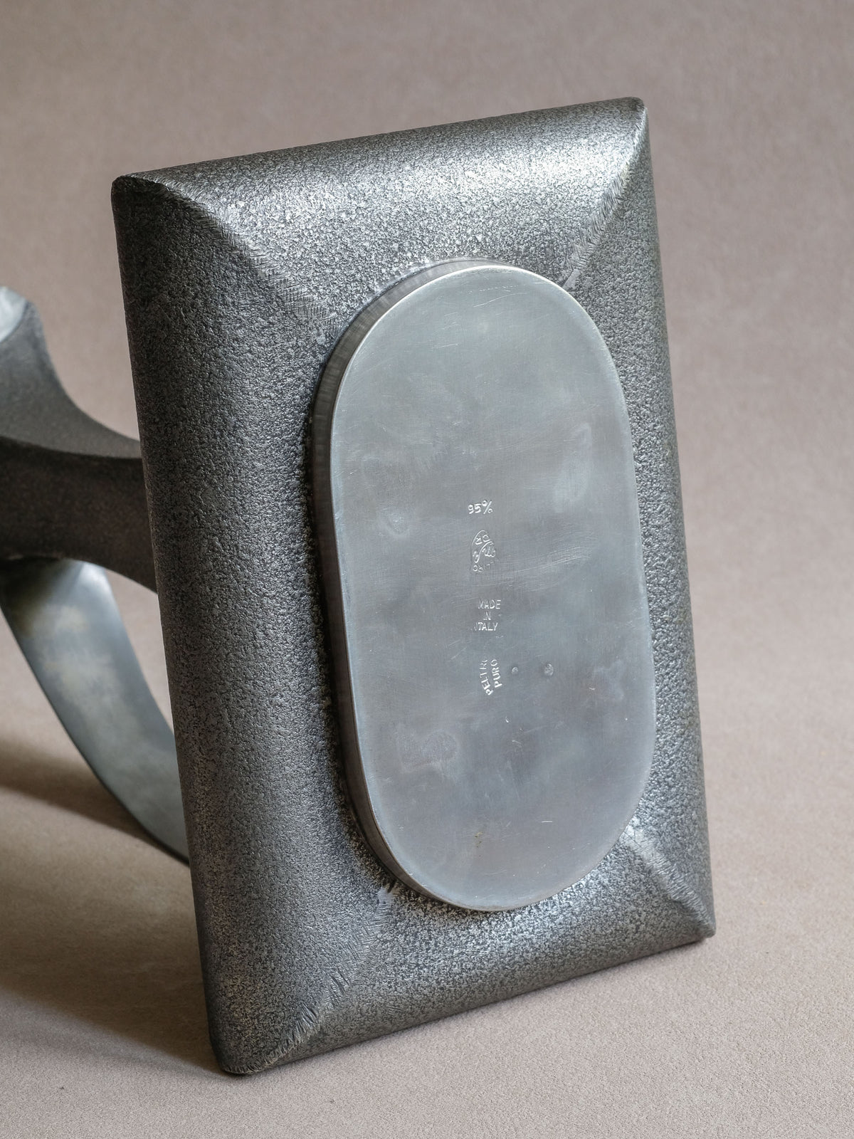Underside stamp on Italian pewter vessel showing 95%, Made in Italy and Peltro Puro markings.