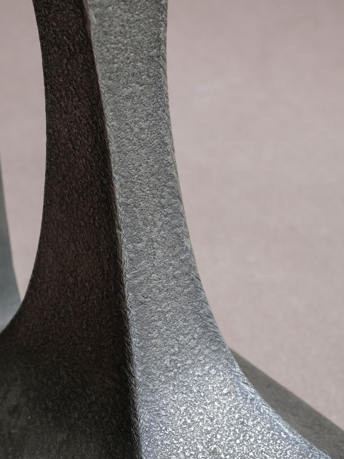 Close-up of the textured pewter neck and contrasting smooth inner surface on the Italian vessel.