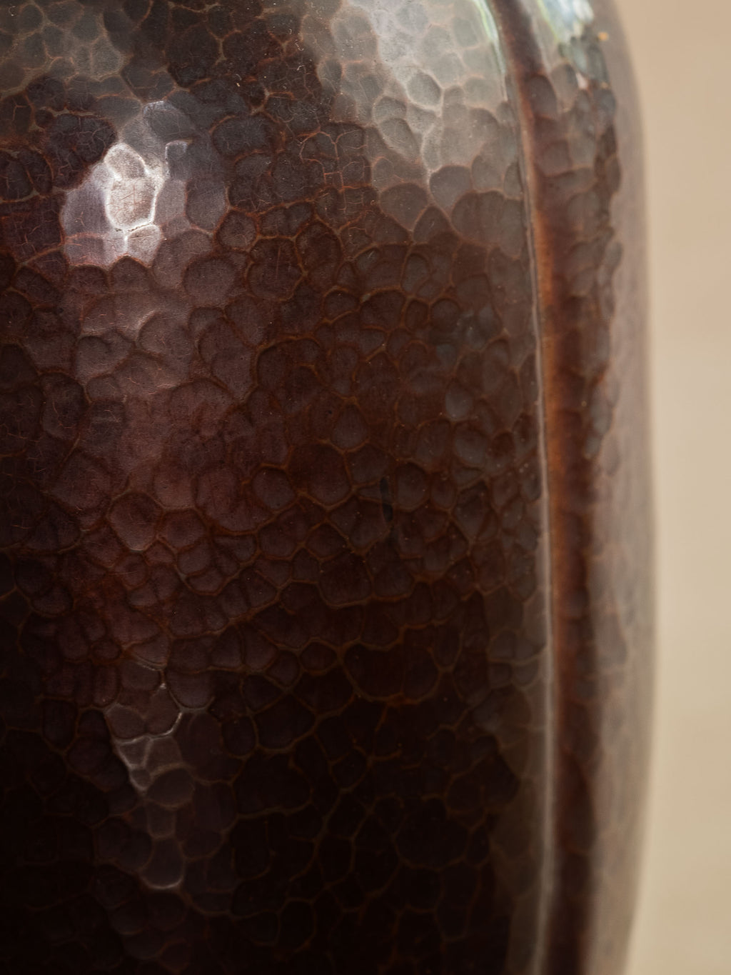 Close-up of Japanese Dochu hand-hammered copper vase showing rich dark patina and tsuchime surface texture.
