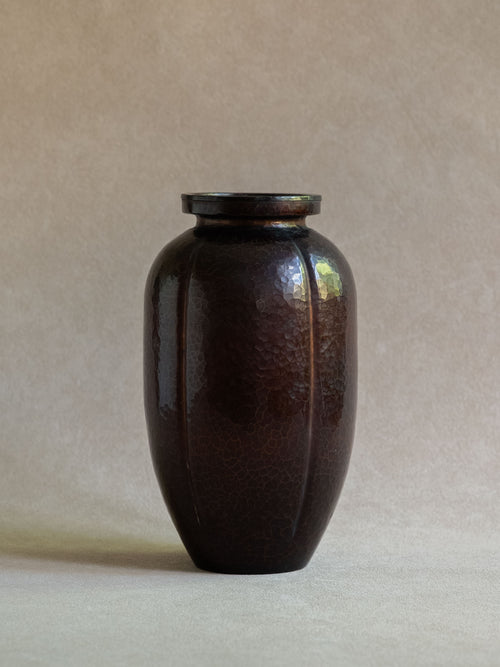Full view of Japanese Dochu copper vase with compact ovoid body, raised rim, and dark hammered surface.
