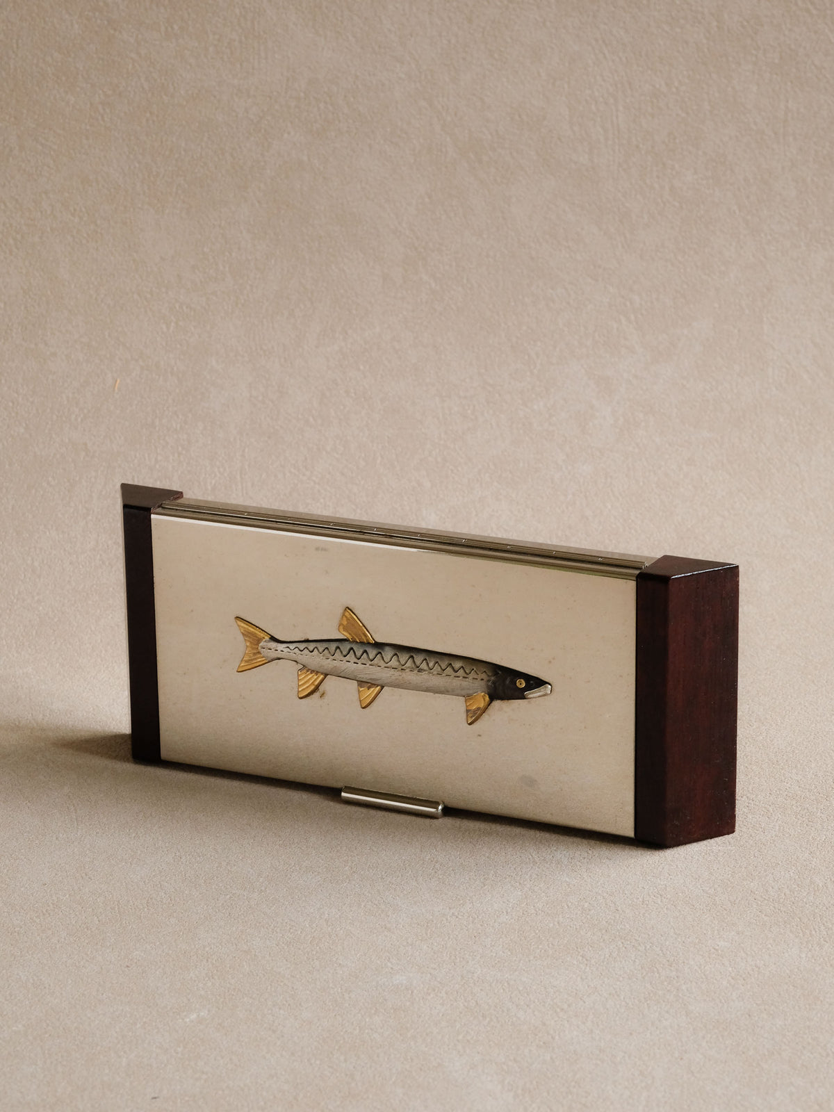 Closer photograph of the fish motif and surface finish on the vintage tray.