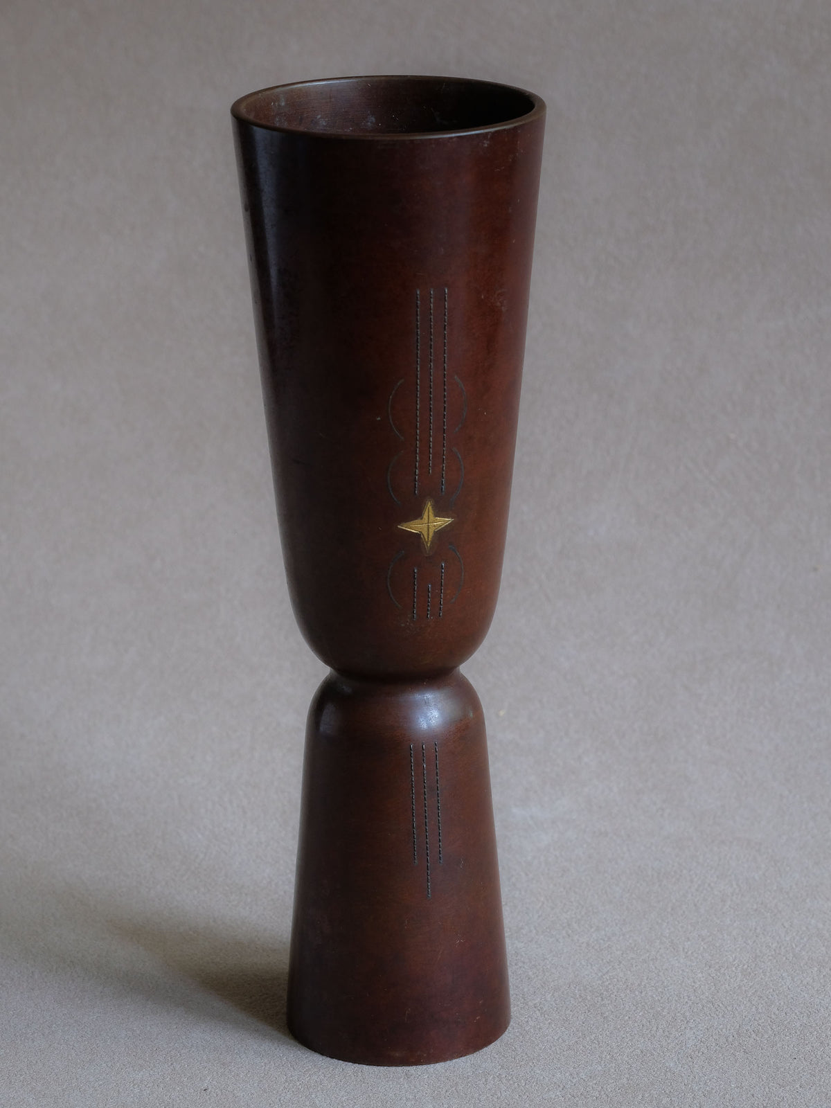 Japanese modernist cast copper vase with tall hourglass form and small gold-coloured zōgan star inlay.