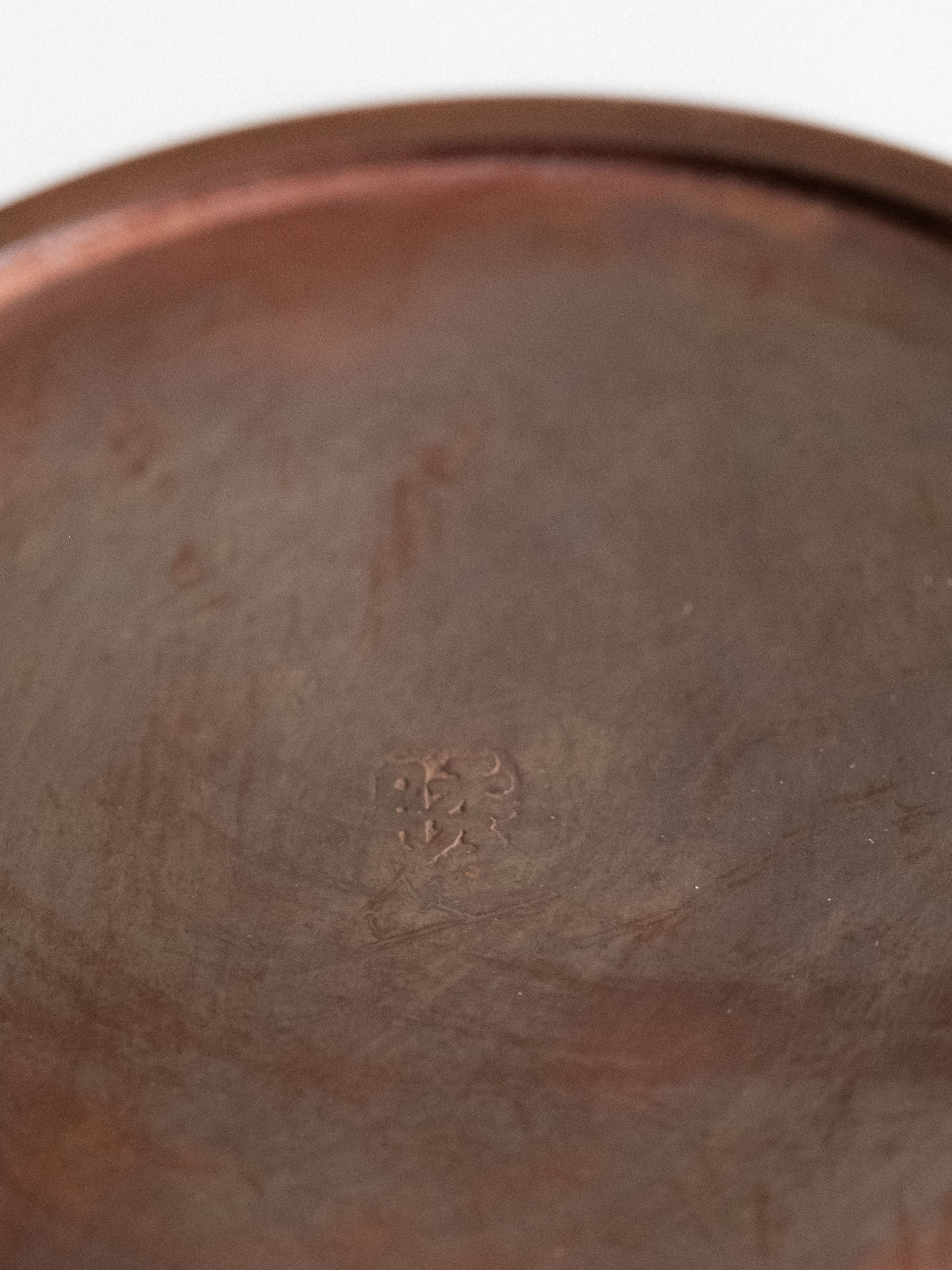 Close-up of the Shugetsu mark on the base of a Japanese Takaoka cast copper vase.
