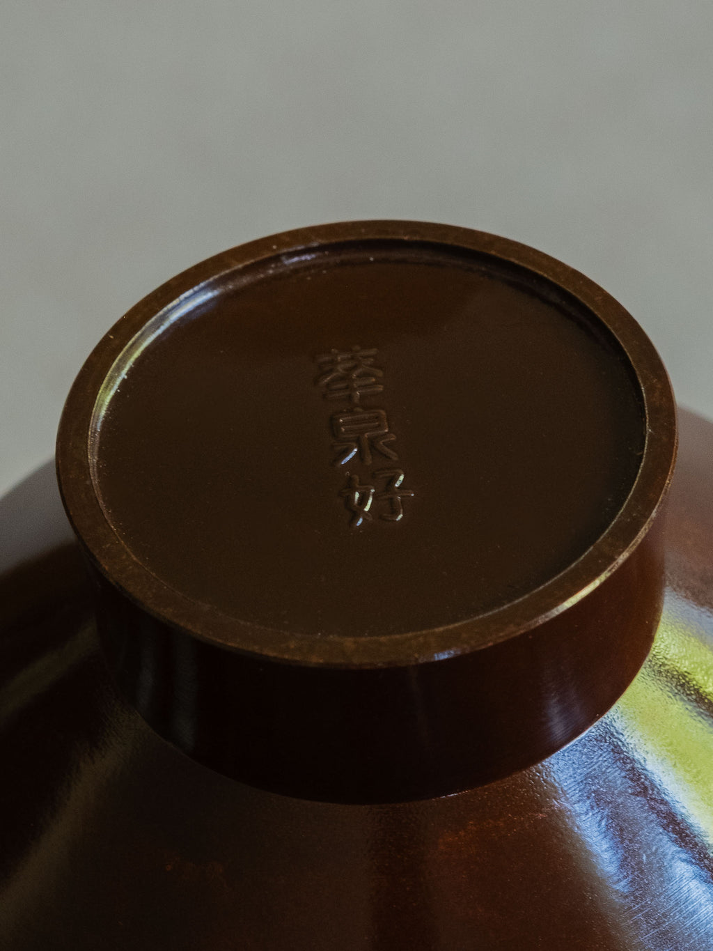 Close-up of the signed base mark on a Japanese patinated copper-alloy single-flower vase.
