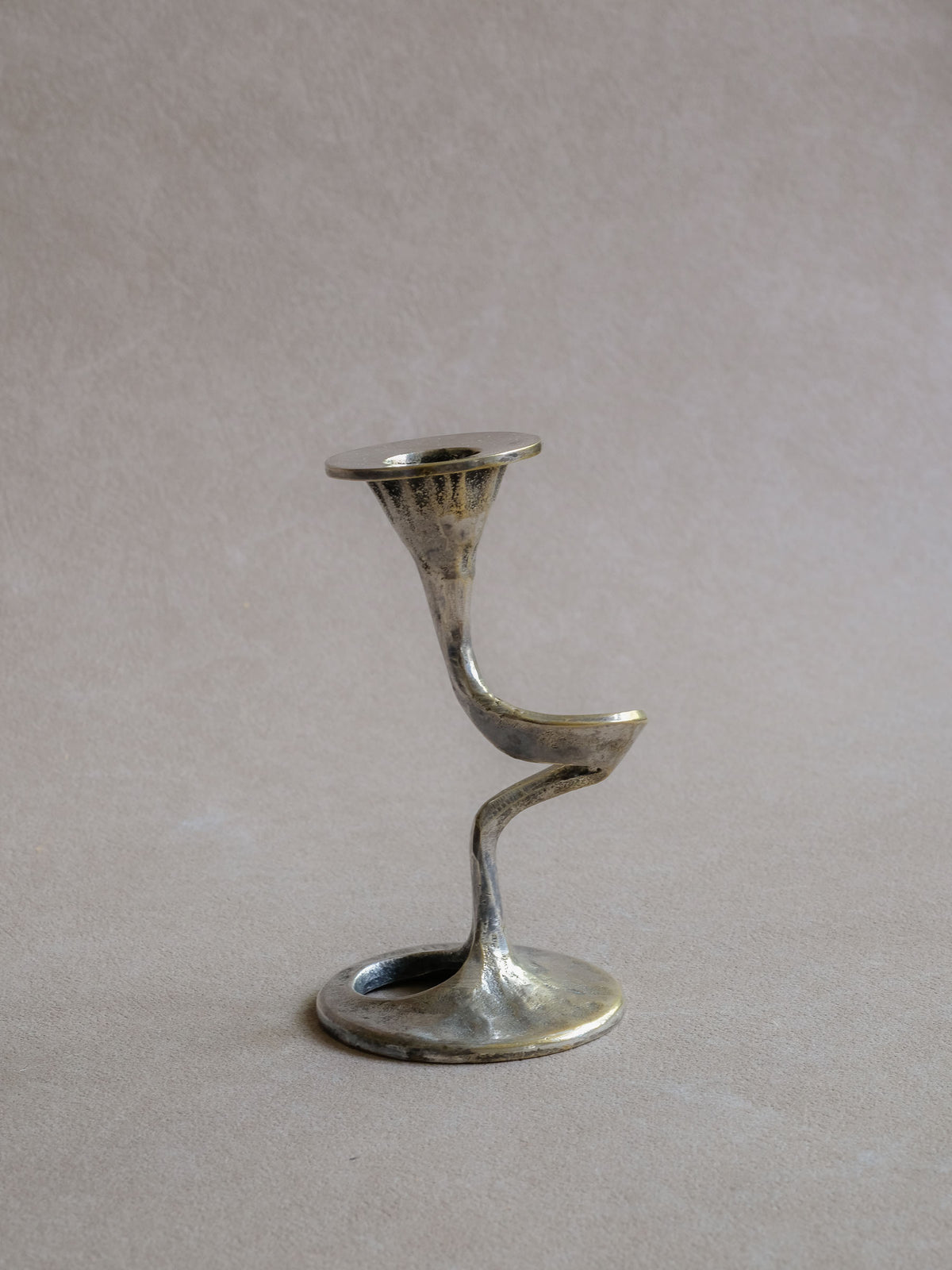 Side view of the Kurt Jesch candleholder showing its flowing S-curve profile and flared candle cup.