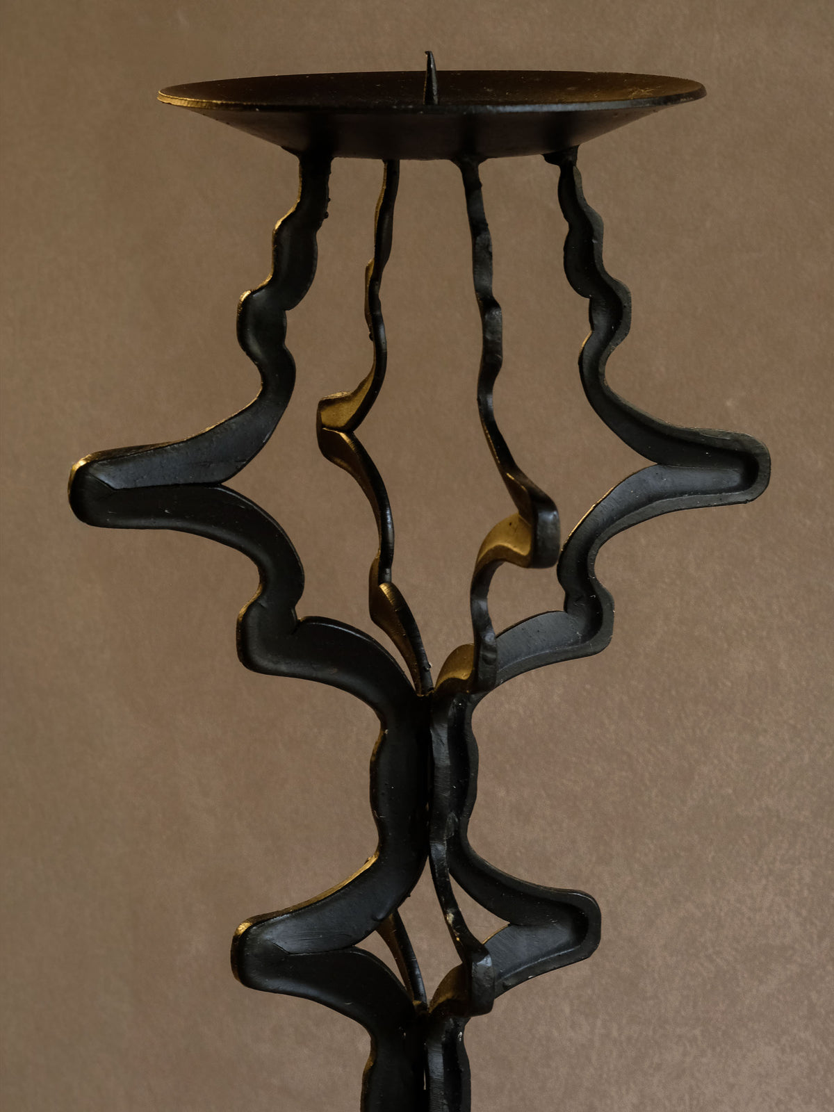 Wide circular top plate of the tall vintage iron floor candleholder.