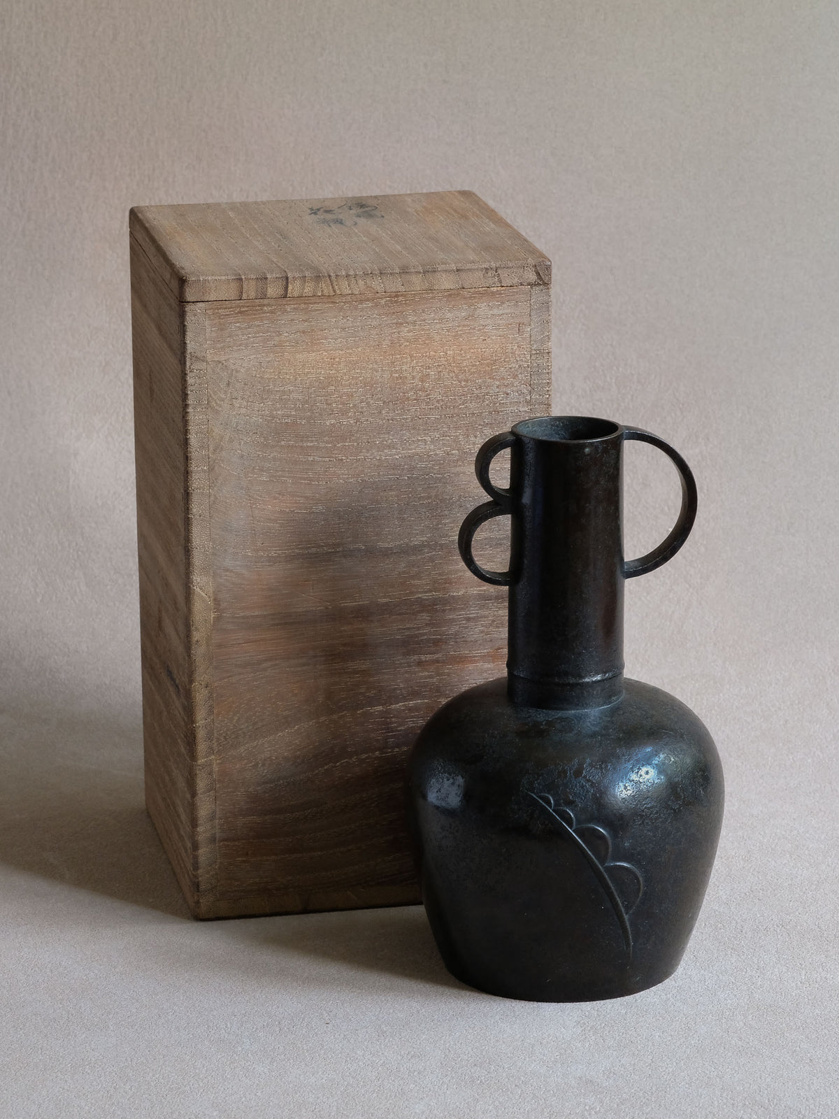 Maruyama Fubo cast copper vase with original wooden box, showing compact body and geometric loop handles.