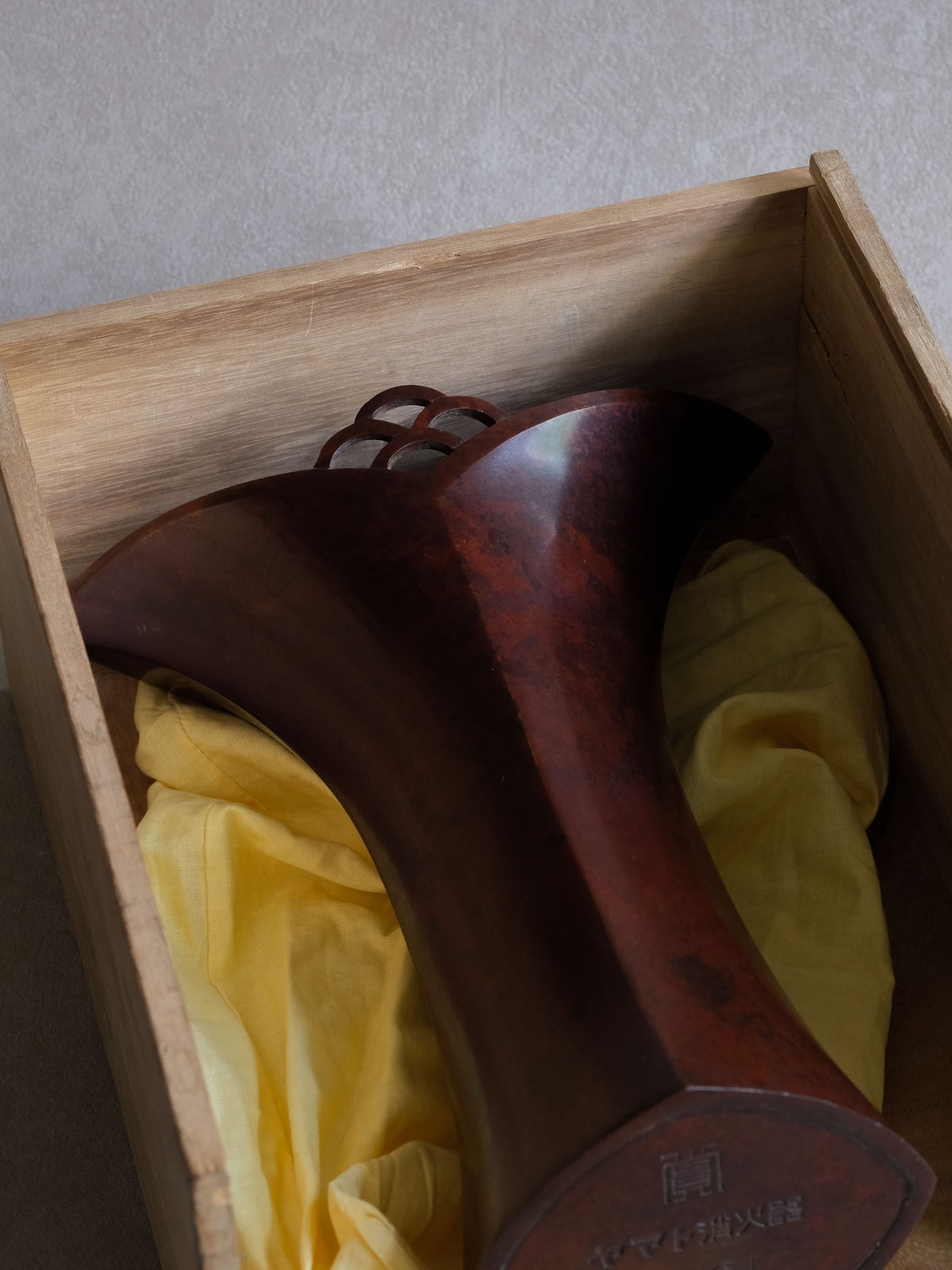 Nakajima Yasumi II vase resting in its repaired original box with yellow protective cloth.