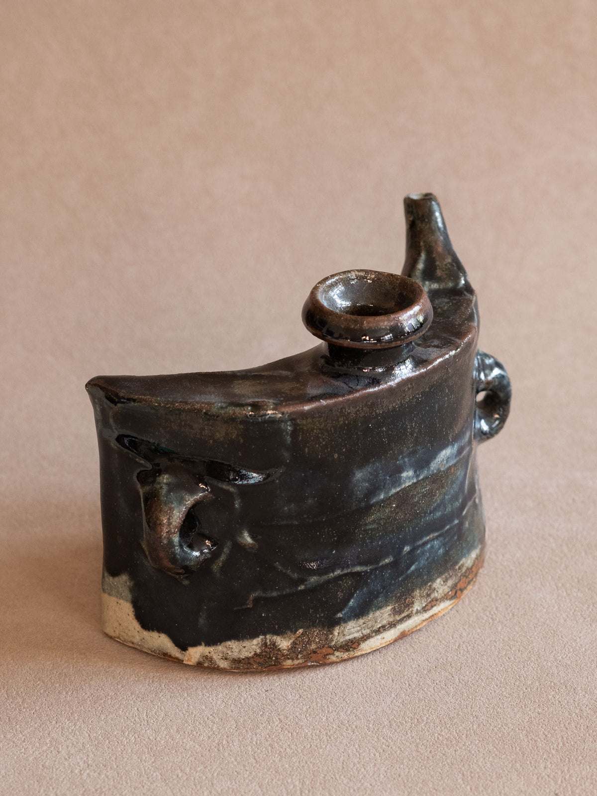 Angled view of the vintage dachibin highlighting the dark glazed surface and curved carrying-flask body.