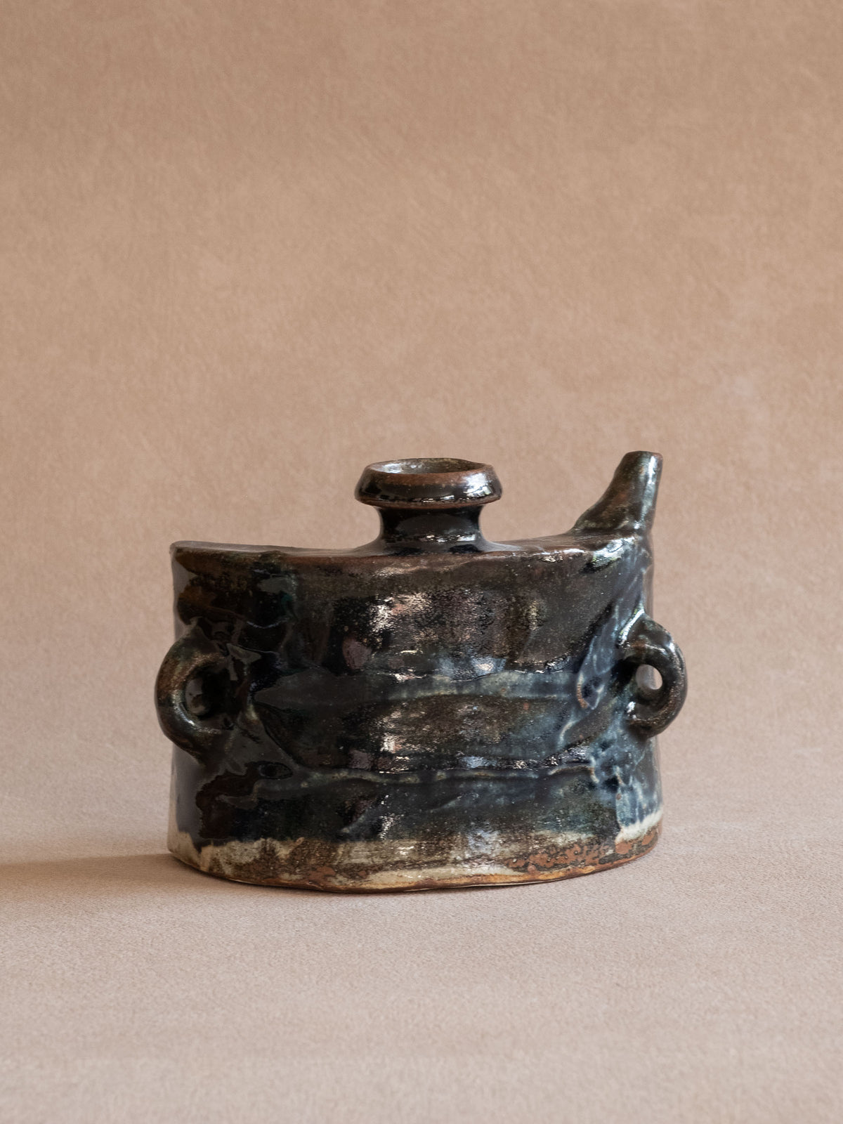 Opposite side view of the Okinawan dachibin showing the carrying lug and compact asymmetric vessel form.
