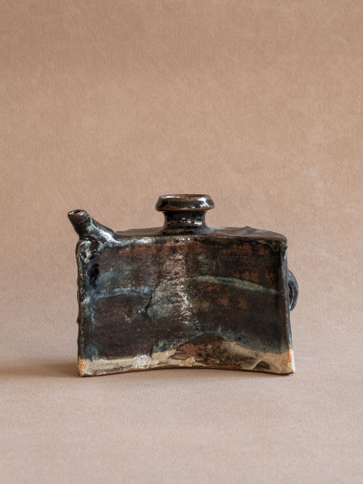 Rear view of the vintage Okinawan ceramic dachibin with dark brown-black glaze over exposed clay.
