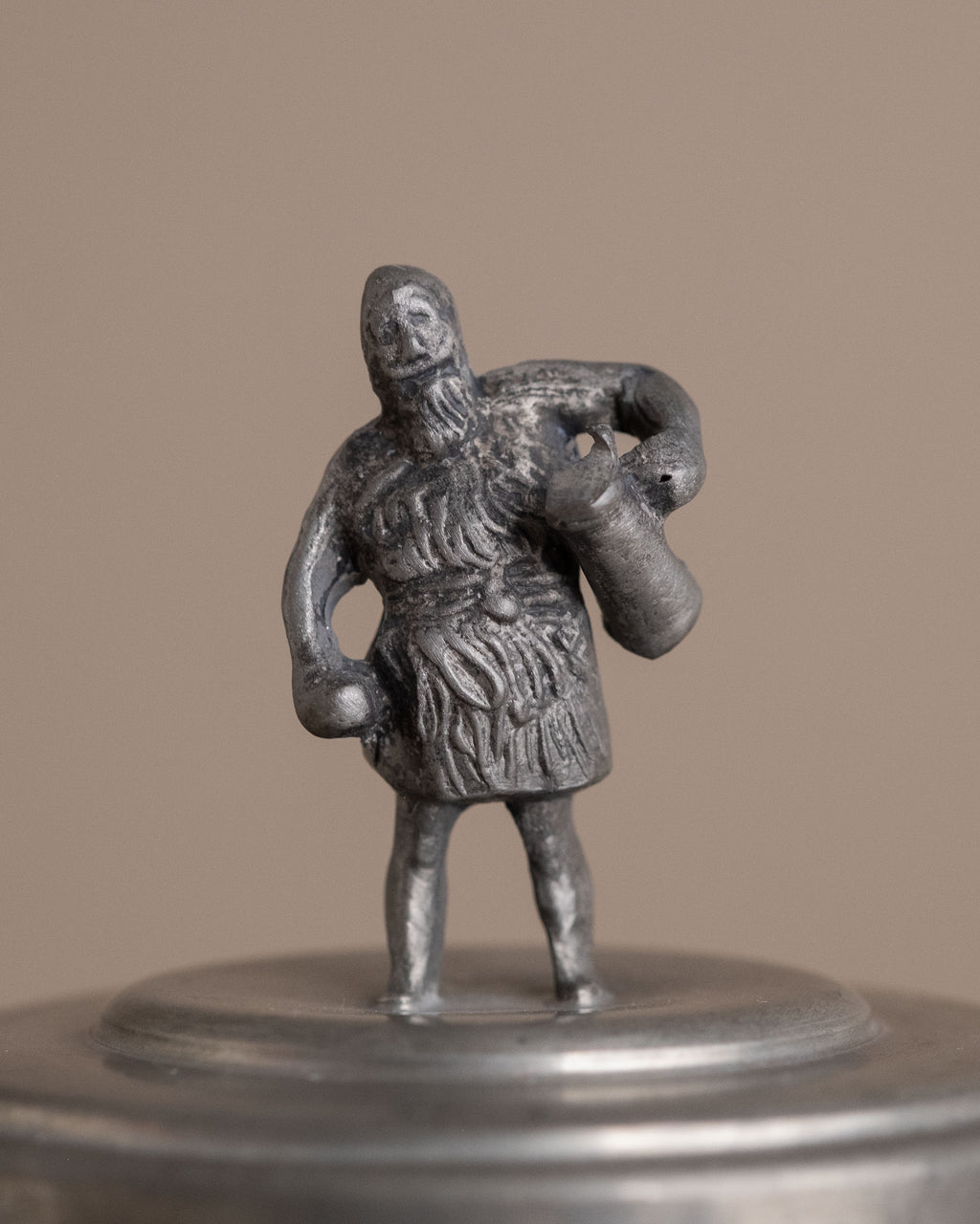 Close-up of the male figure finial on the lid of a small Savo Tinn pewter lidded box from Norway.