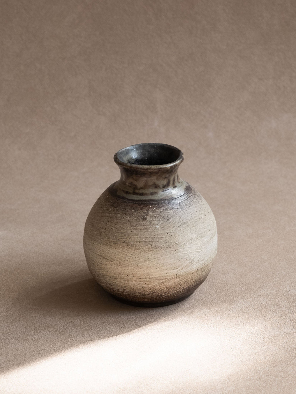 Side view highlighting the fine horizontal texture across the pale ceramic body.