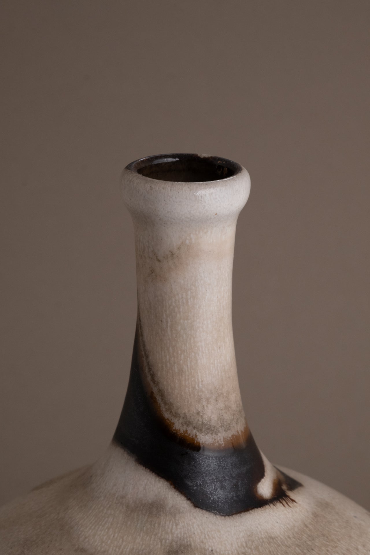 Close view of the tall narrow neck and dark glazed band on the Elly and Wilhelm Kuch vase.