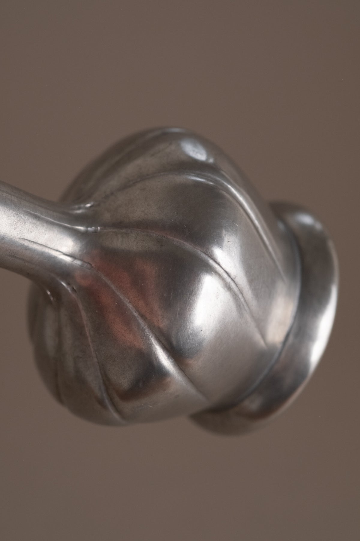 Detail view of the spiral modelling around the body of the vintage 95% pewter vase.