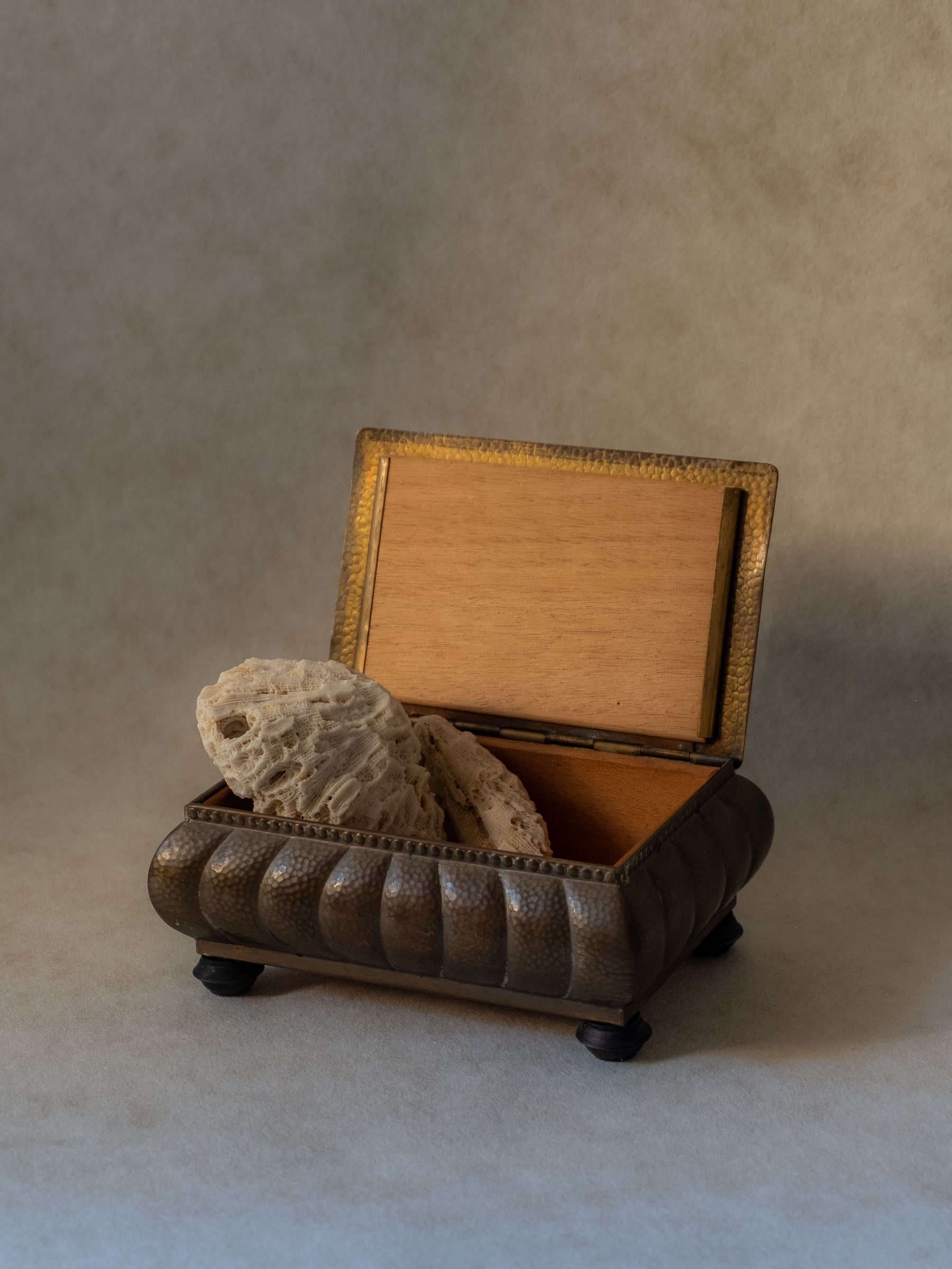 WMF hammered brass jewellery box with Bakelite feet, open to show wooden lining, Germany, 1928–1935.