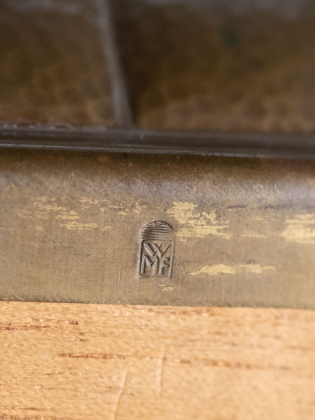 Close-up of WMF maker’s mark on hammered brass jewellery box, Germany, 1928–1935.
