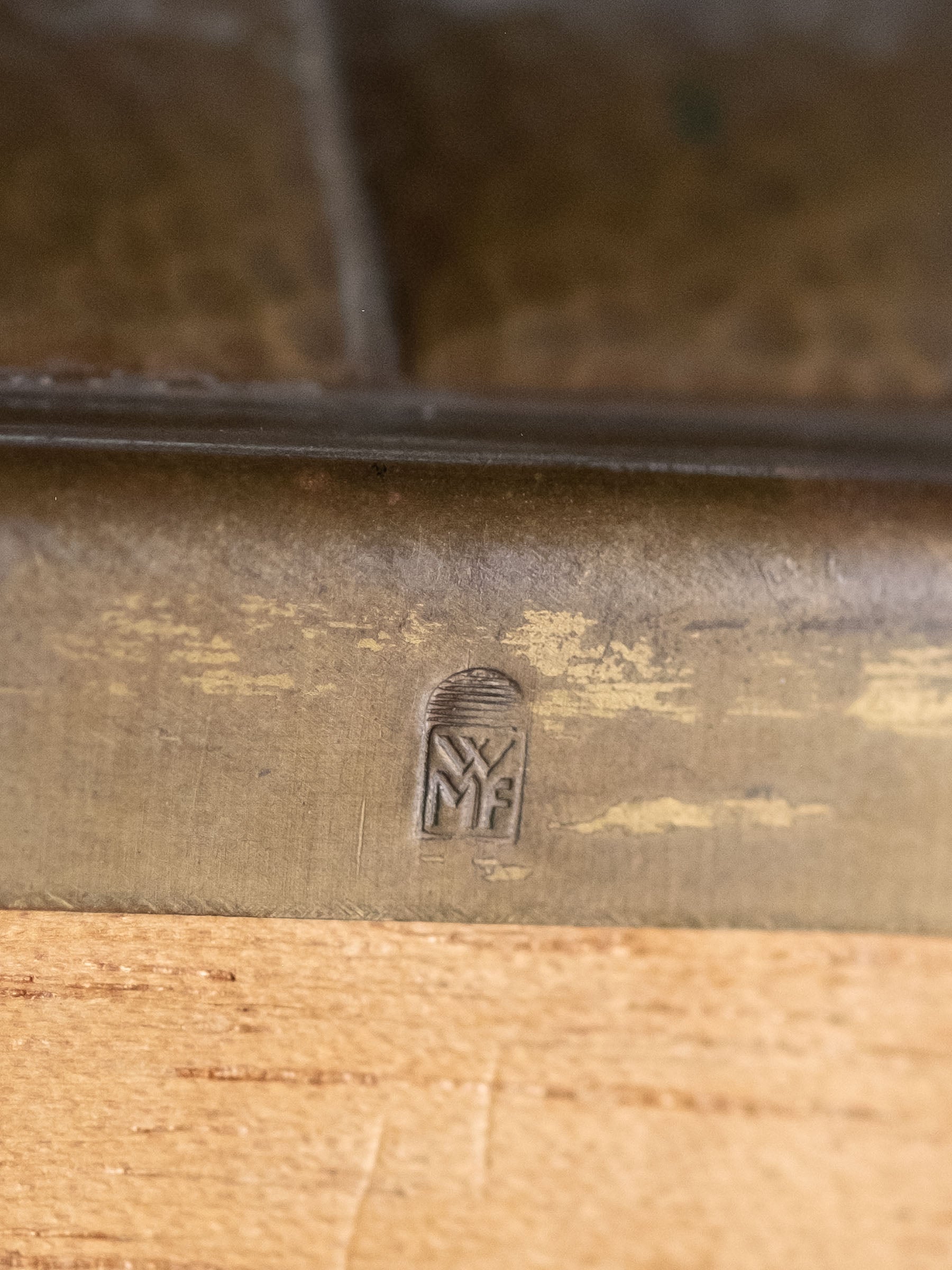 Close-up of WMF maker’s mark on hammered brass jewellery box, Germany, 1928–1935.